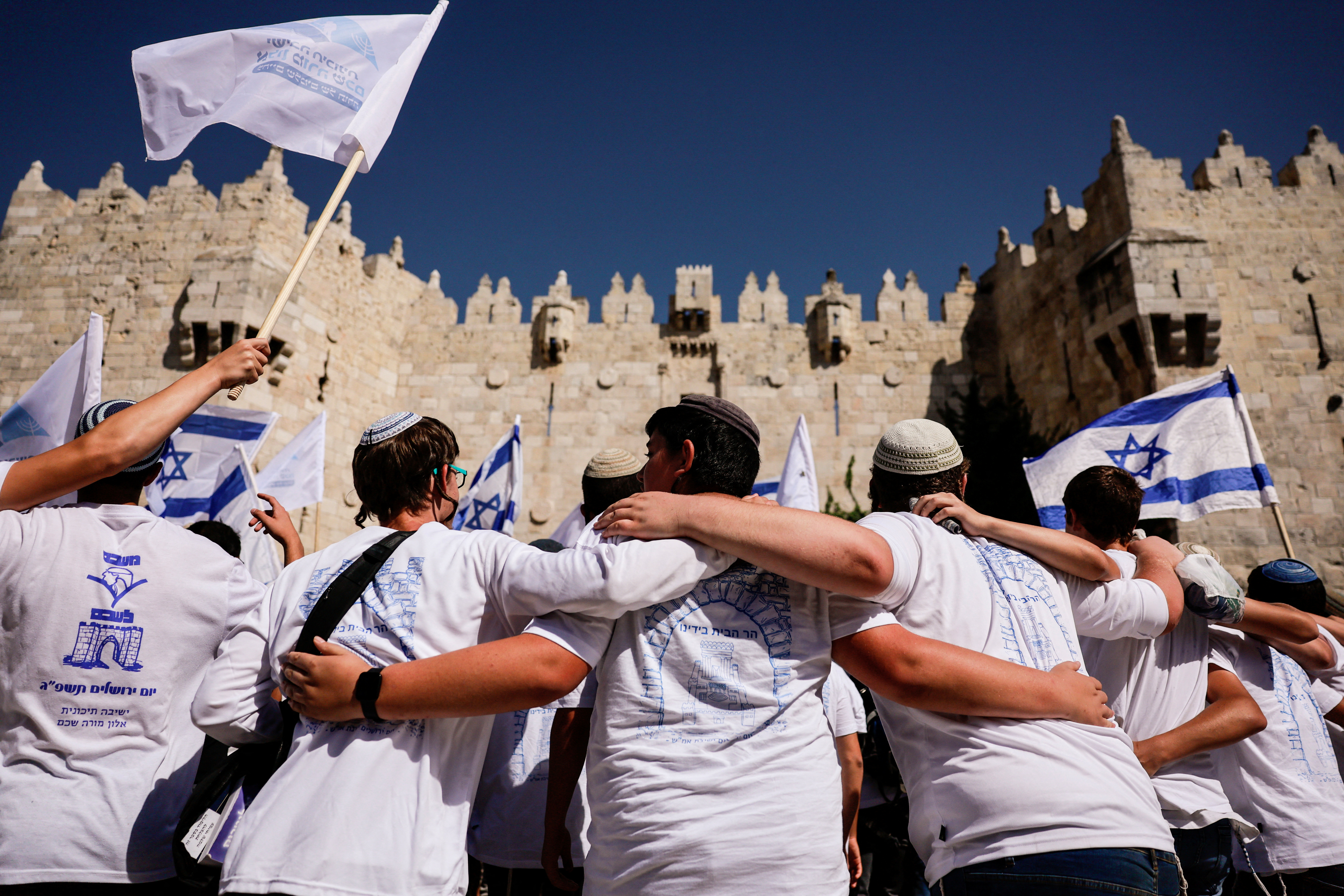 Israelis march through the alleyways of Jerusalem's Old City to the Western Wall, waving Israeli flags on 'Jerusalem Day' to commemorate the establishment of Israeli control over the city.