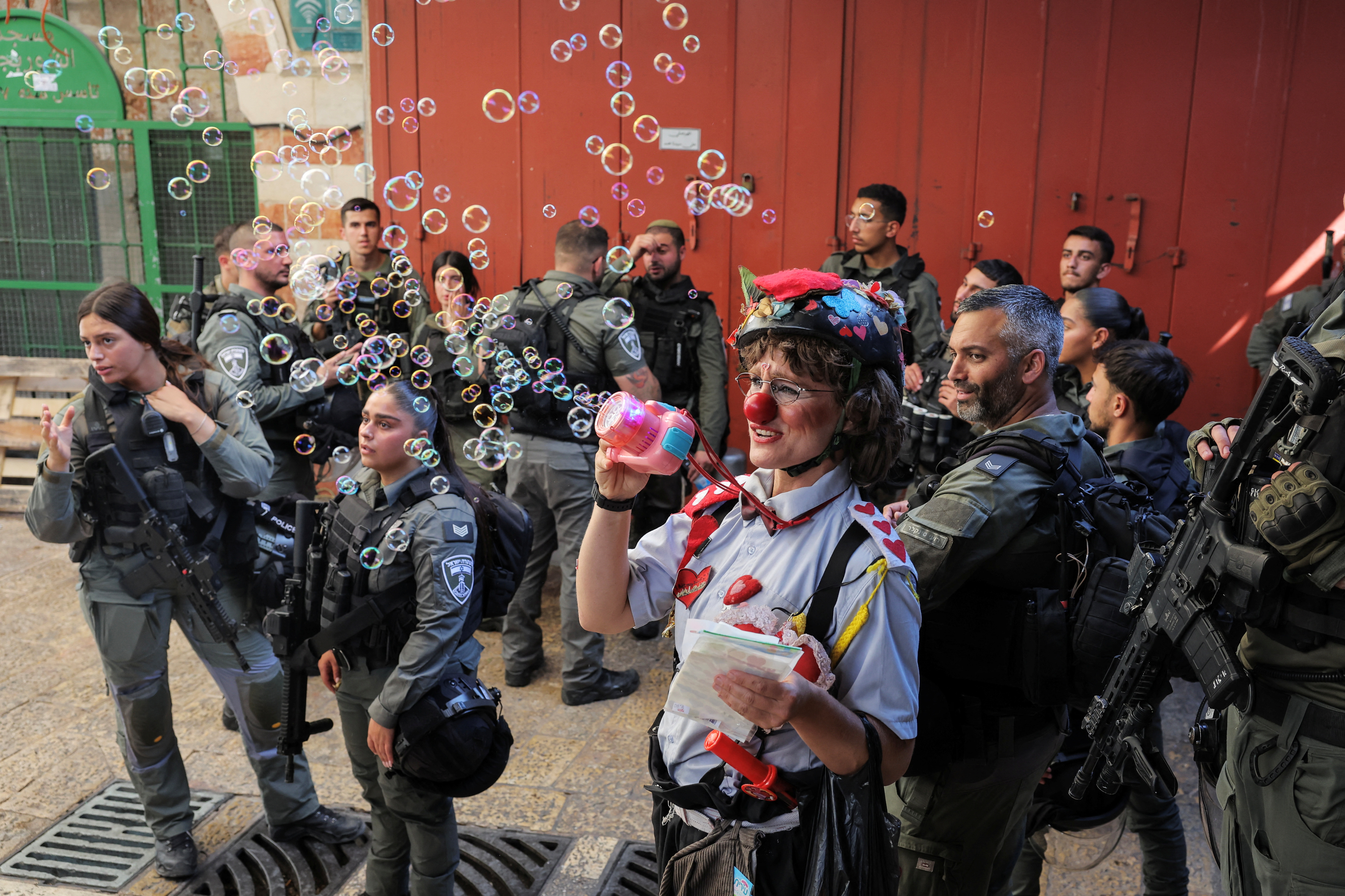 Israelis march through the alleyways of Jerusalem's Old City to the Western Wall, waving Israeli flags on 'Jerusalem Day' to commemorate the establishment of Israeli control over the city.