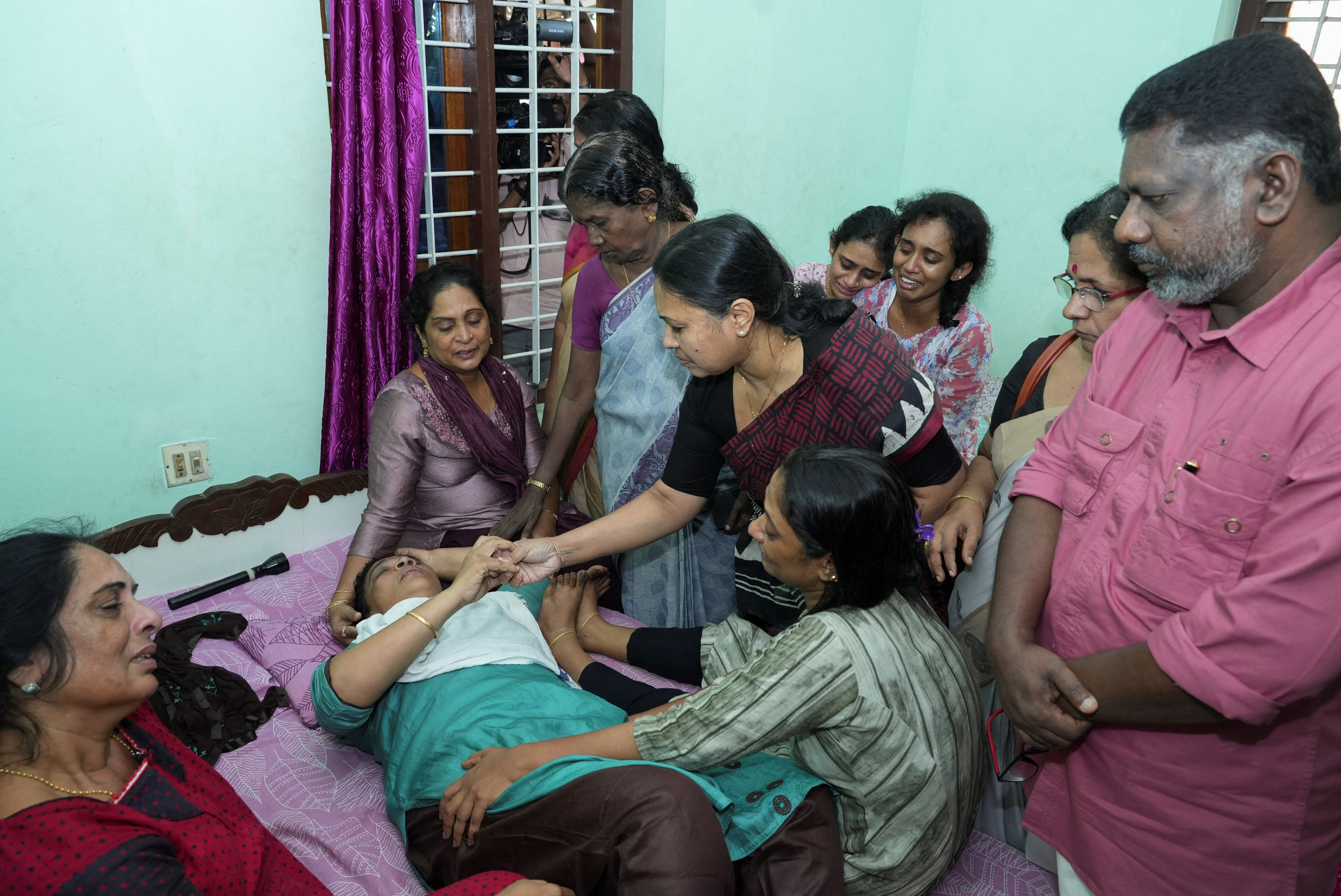 Kerala's Minister for Health and Woman and Child Development Veena George consoles the mother of a victim of Kuwait fire