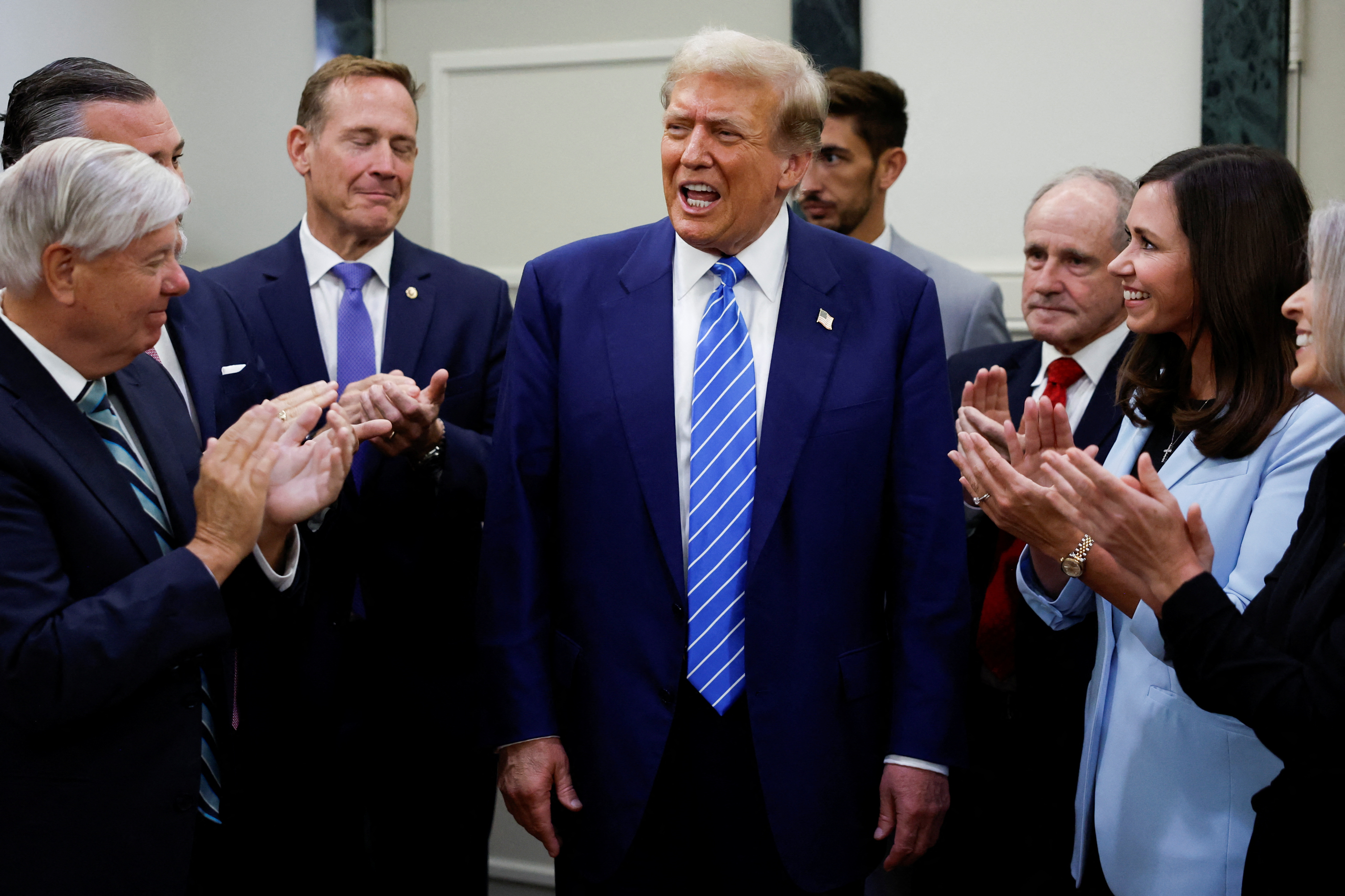 Former US President Donald Trump is applauded by Republicans
