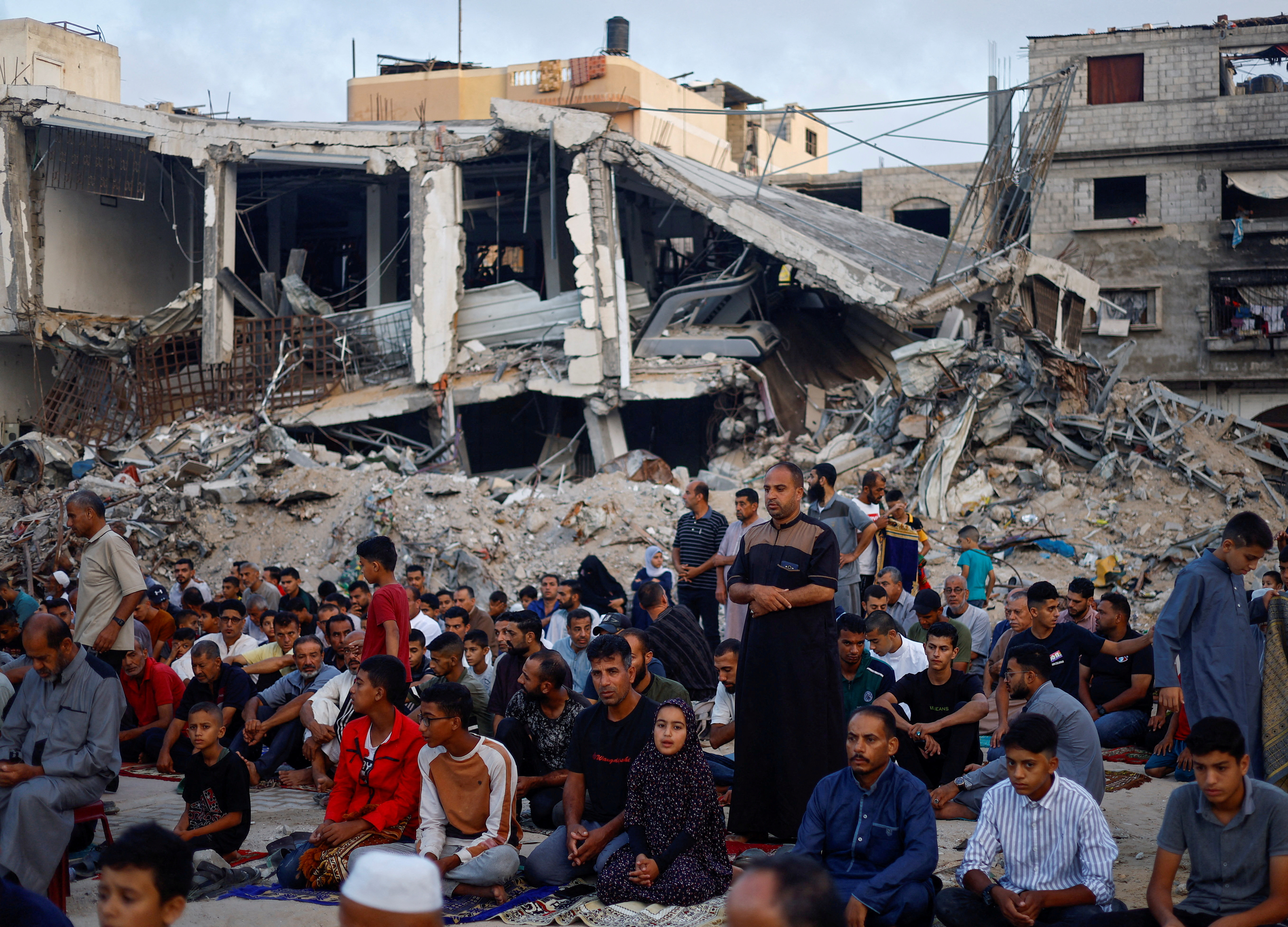 Palestinians hold Eid al-Adha prayers by the ruins of the Al-Rahma mosque destroyed by Israeli air strikes, amid the Israel-Hamas conflict, in Khan Younis, in the southern Gaza Strip, June 16