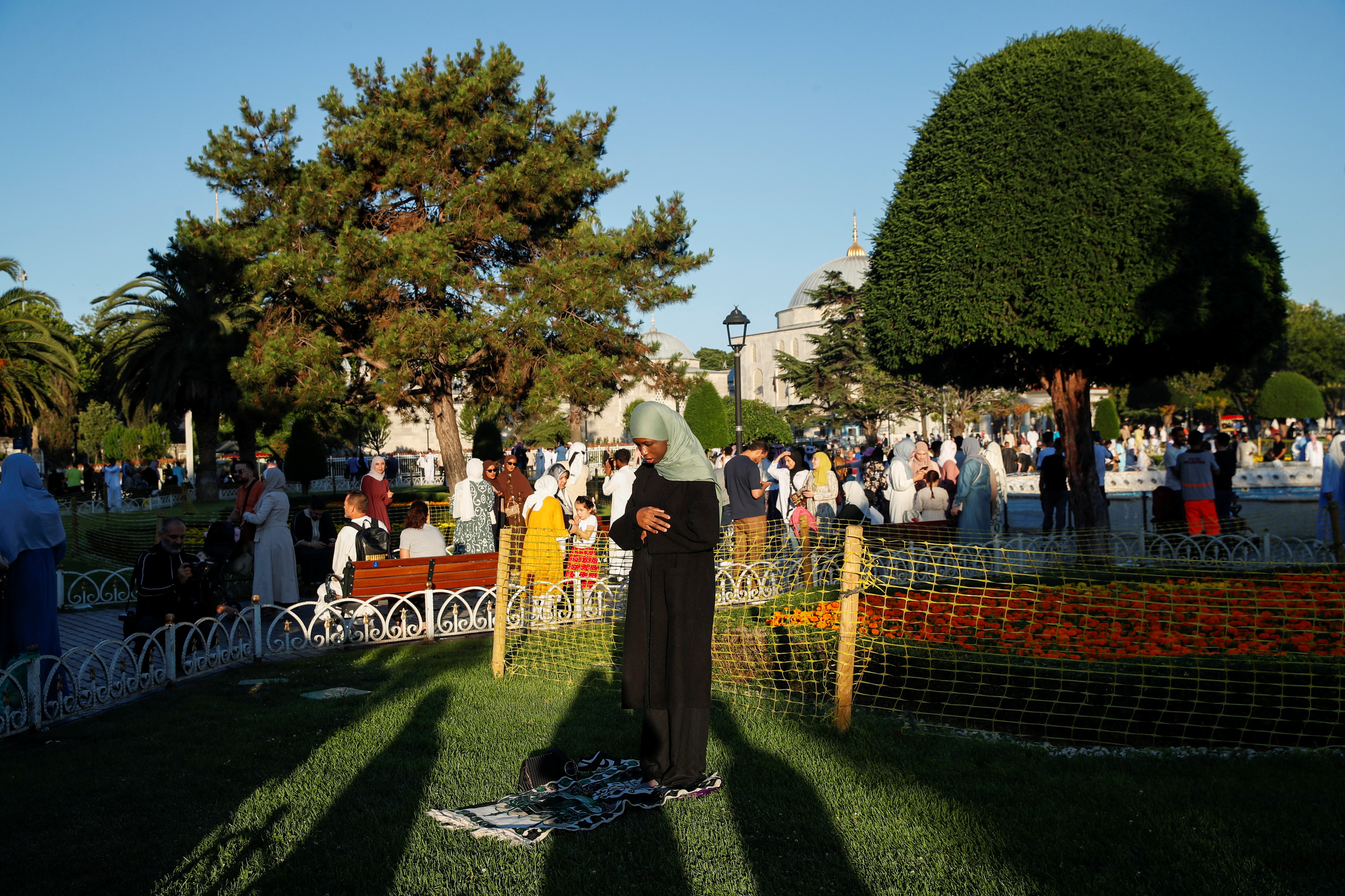 A woman prays on the first day of the Muslim holiday of Eid al-Adha, the Feast of Sacrifice, at Sultanahmet Square in Istanbul, Turkey June 16