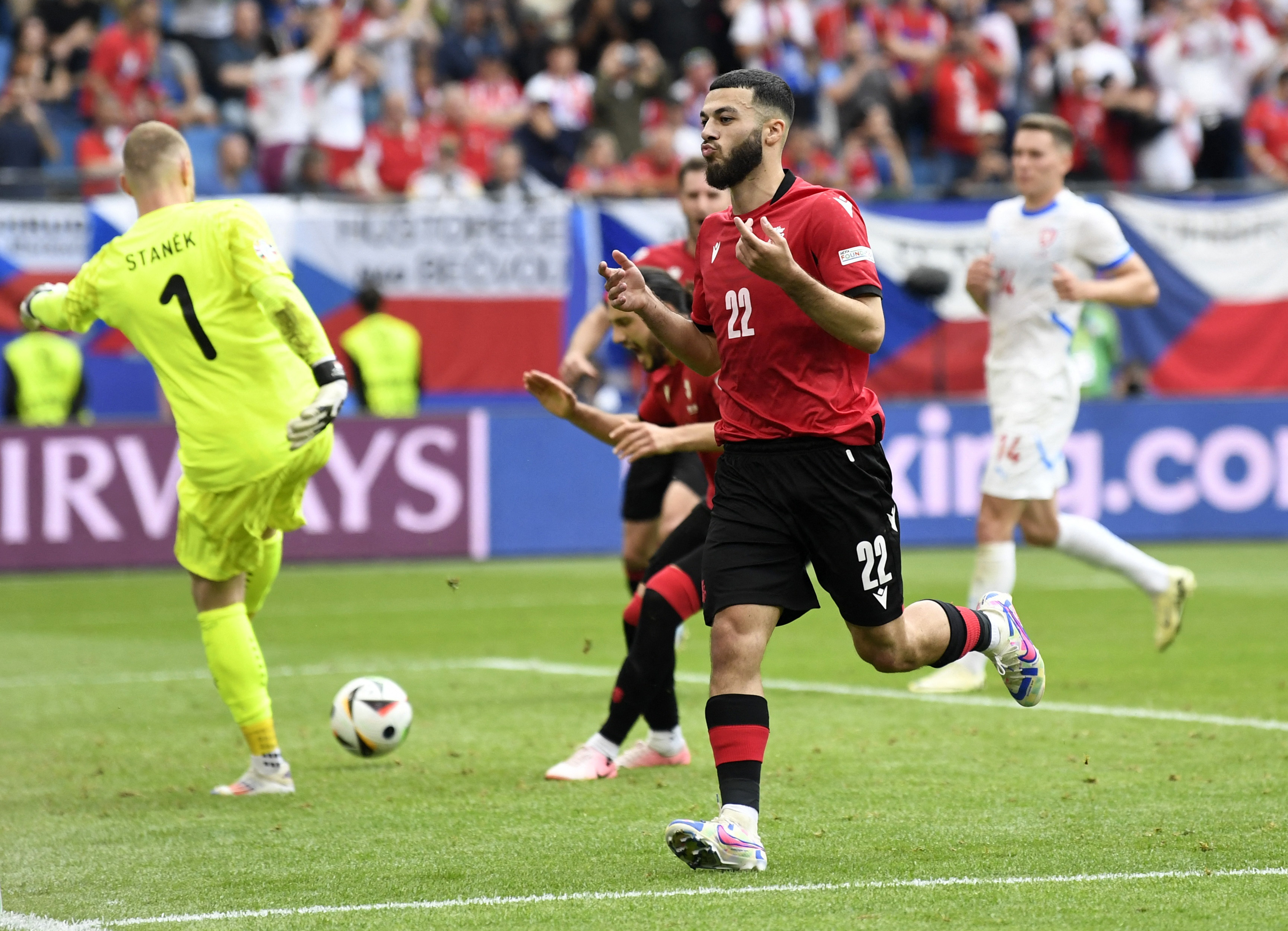 Football player celebrates after scoring goal.