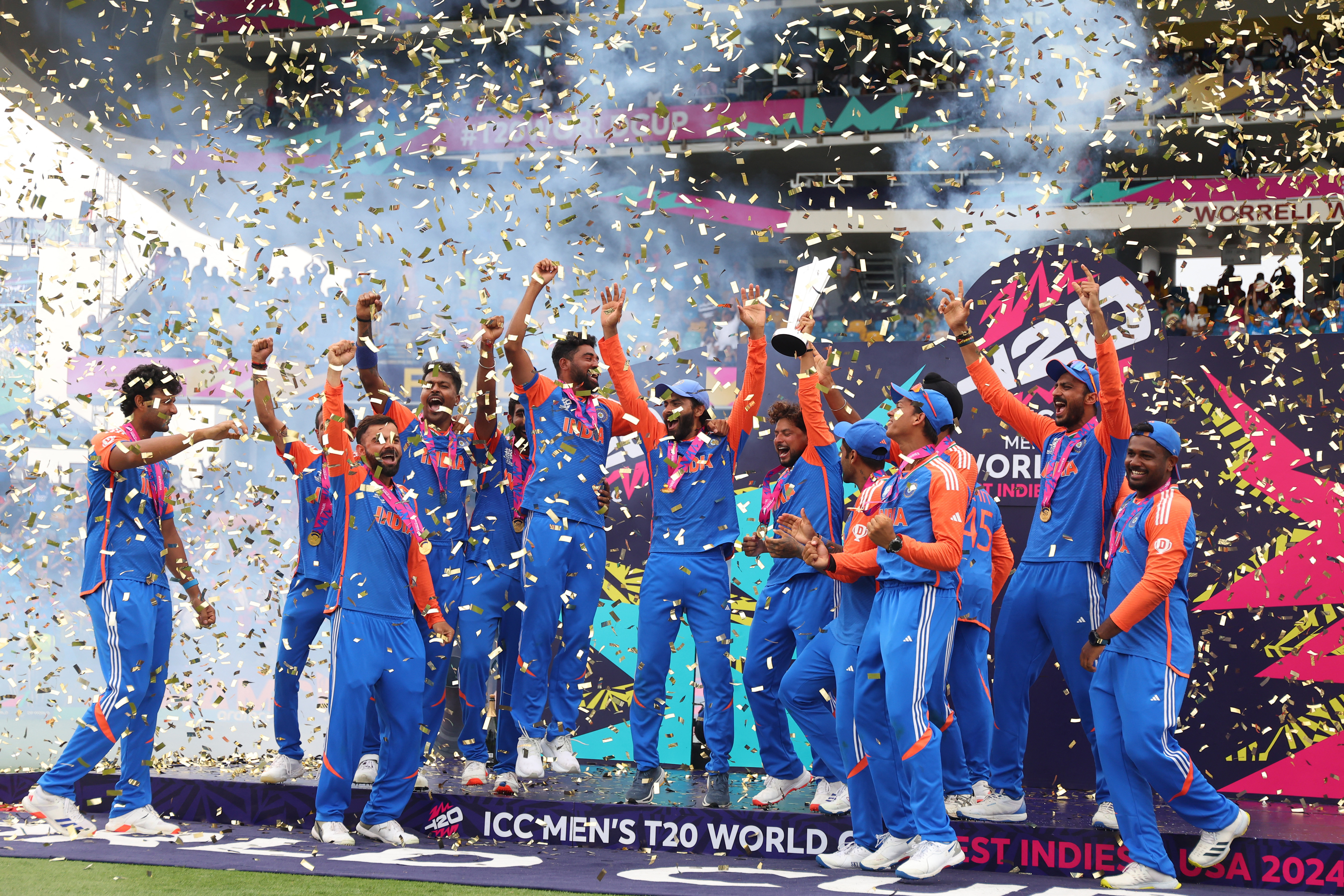 India's Kuldeep Yadav lifts the trophy as they celebrate after winning the T20 World Cup