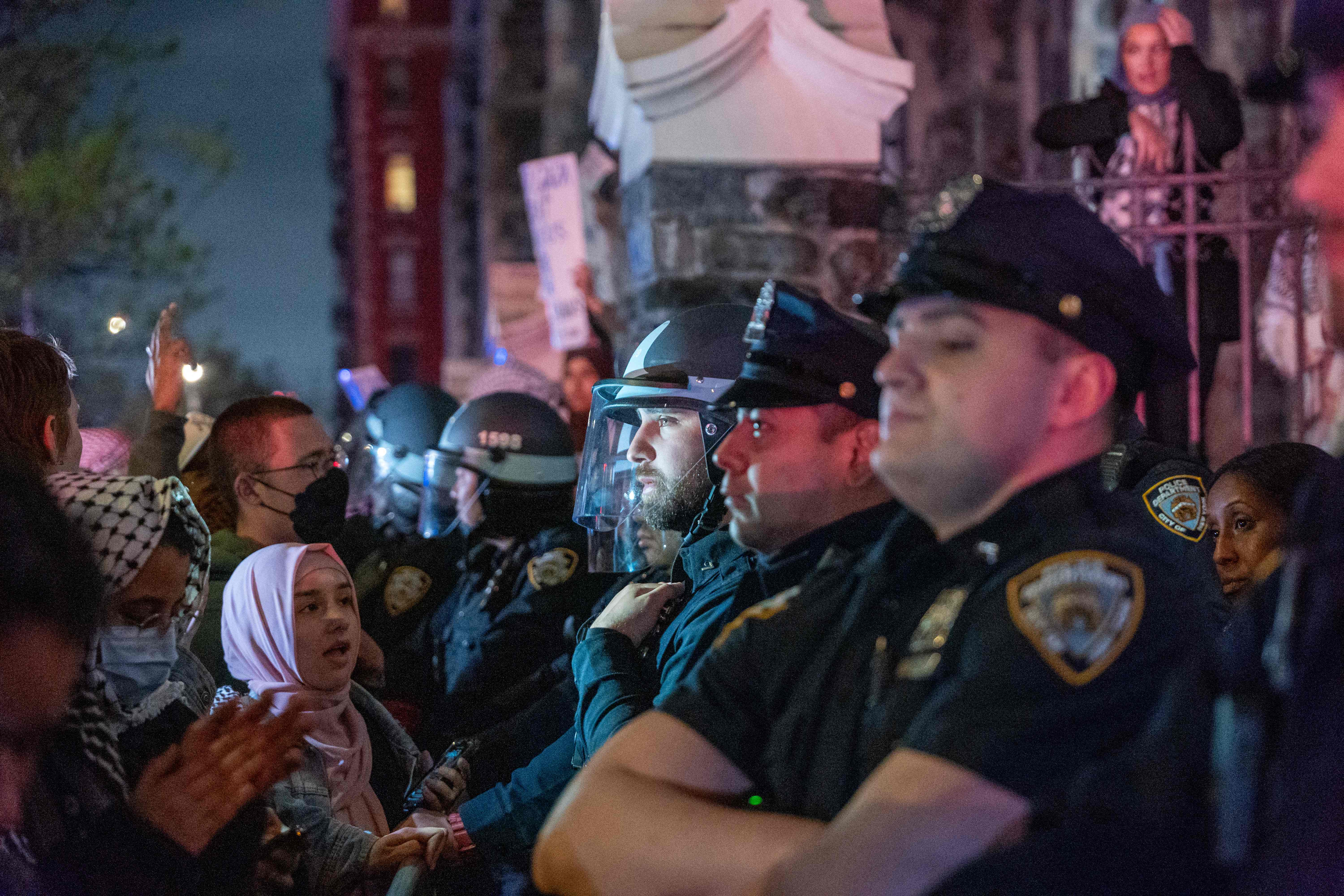 Pro-Palestinian supporters confront police during demonstrations at The City College Of New York (CUNY) as the NYPD cracks down on protest camps on April 30, 2024 in New York City. [Spencer Platt/Getty Images/AFP]