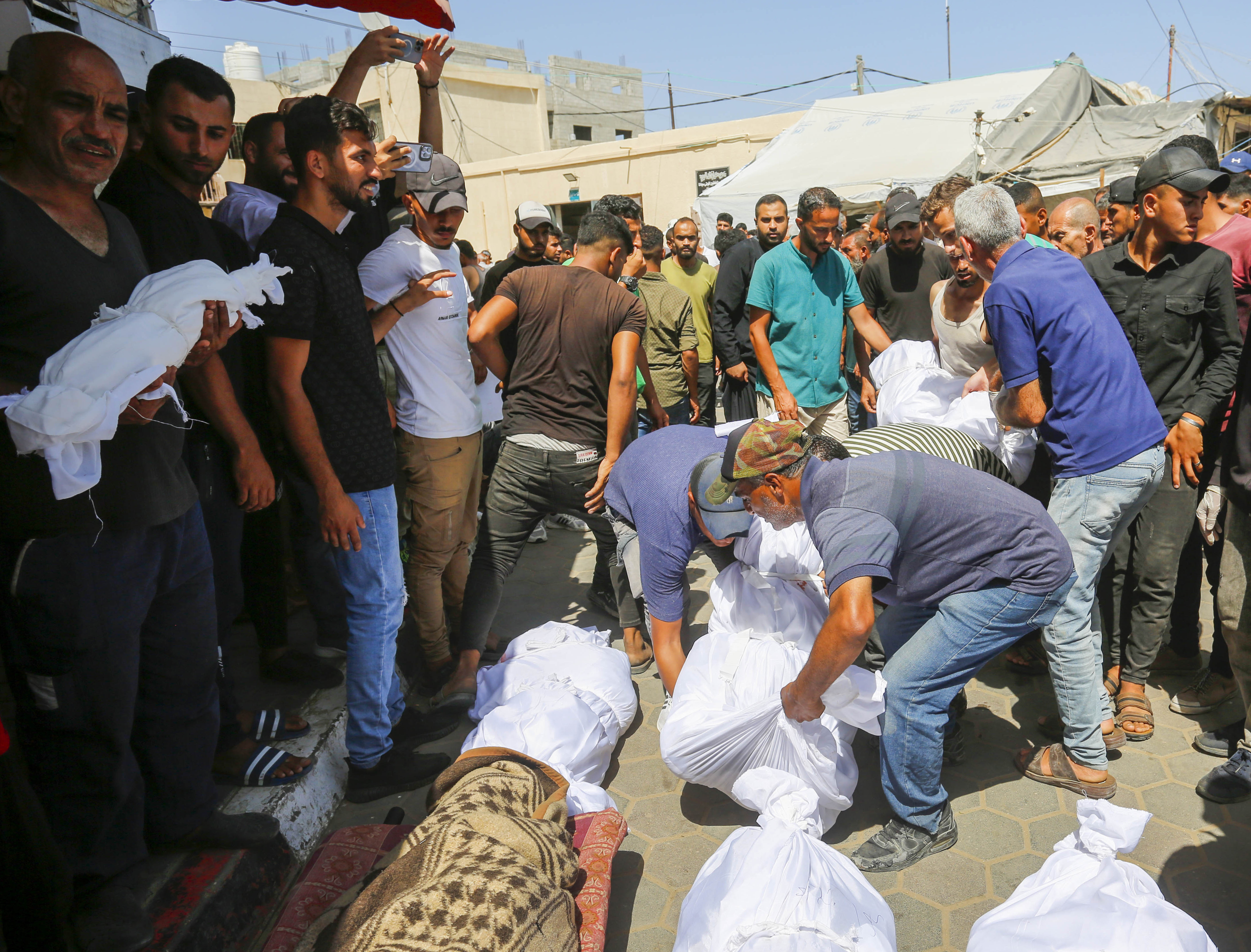 The bodies of Palestinians killed in the Israeli attack are brought to the morgue of Al-Aqsa Martyrs Hospital in Deir al-Balah, Gaza on June 8