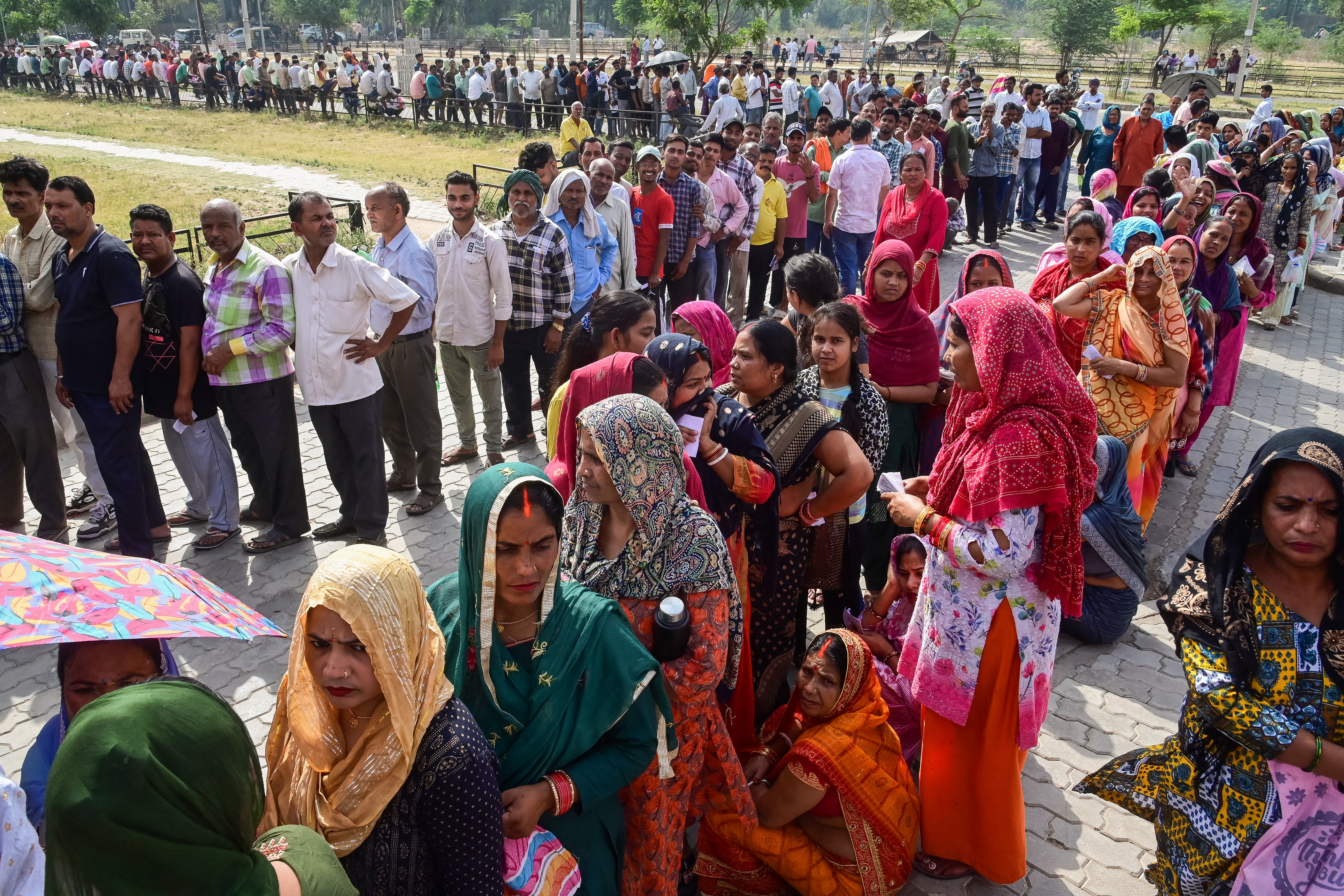Voters queue up to cast their ballots at a polling station during the seventh and final phase of voting in India's general election in Chandigarh on June 1