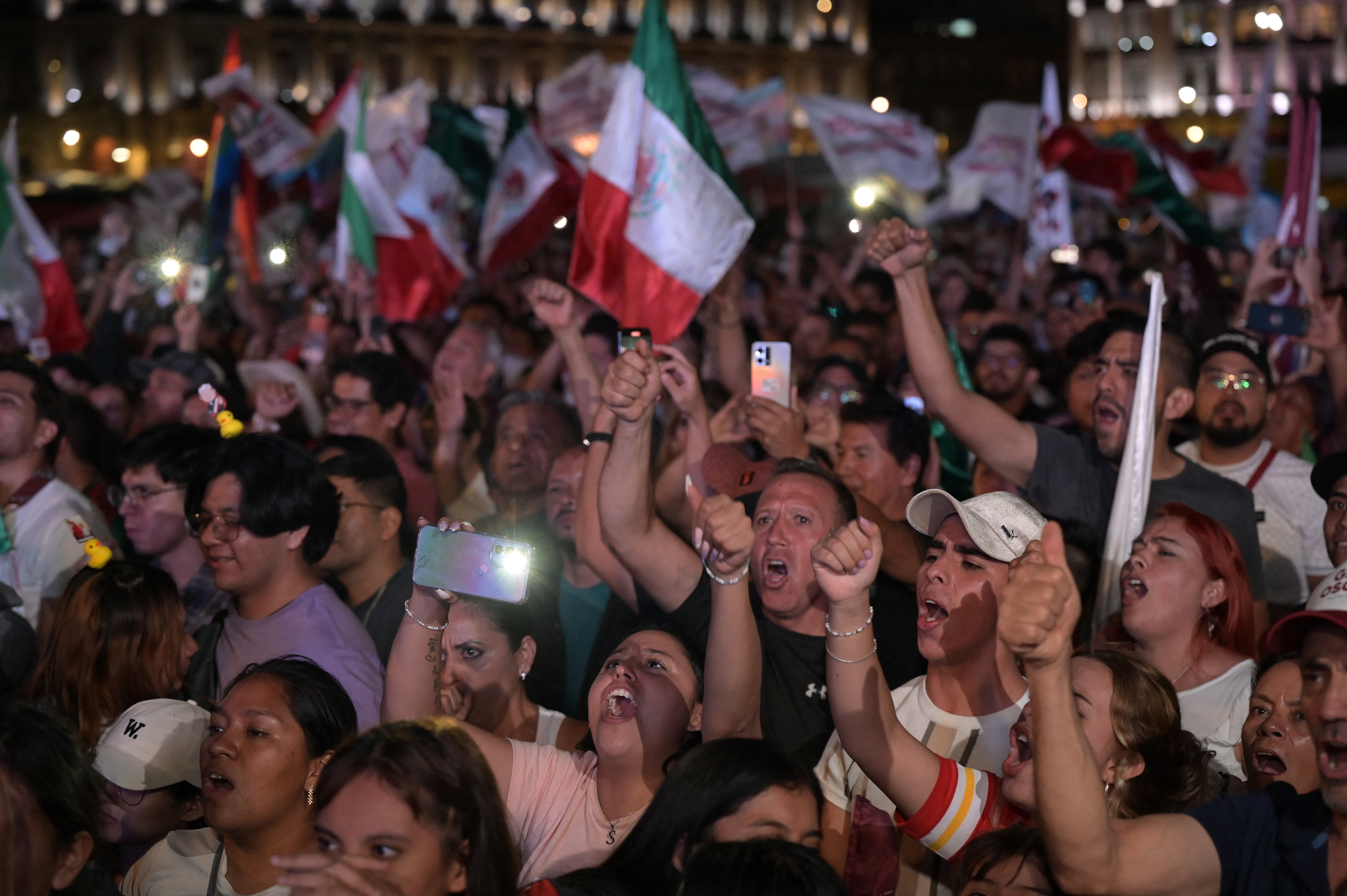 Supporters of Mexico's presidential candidate for Morena party Claudia Sheinbaum celebrate following the results of the general election at Zocalo Square in Mexico City, on June 3, 2024.