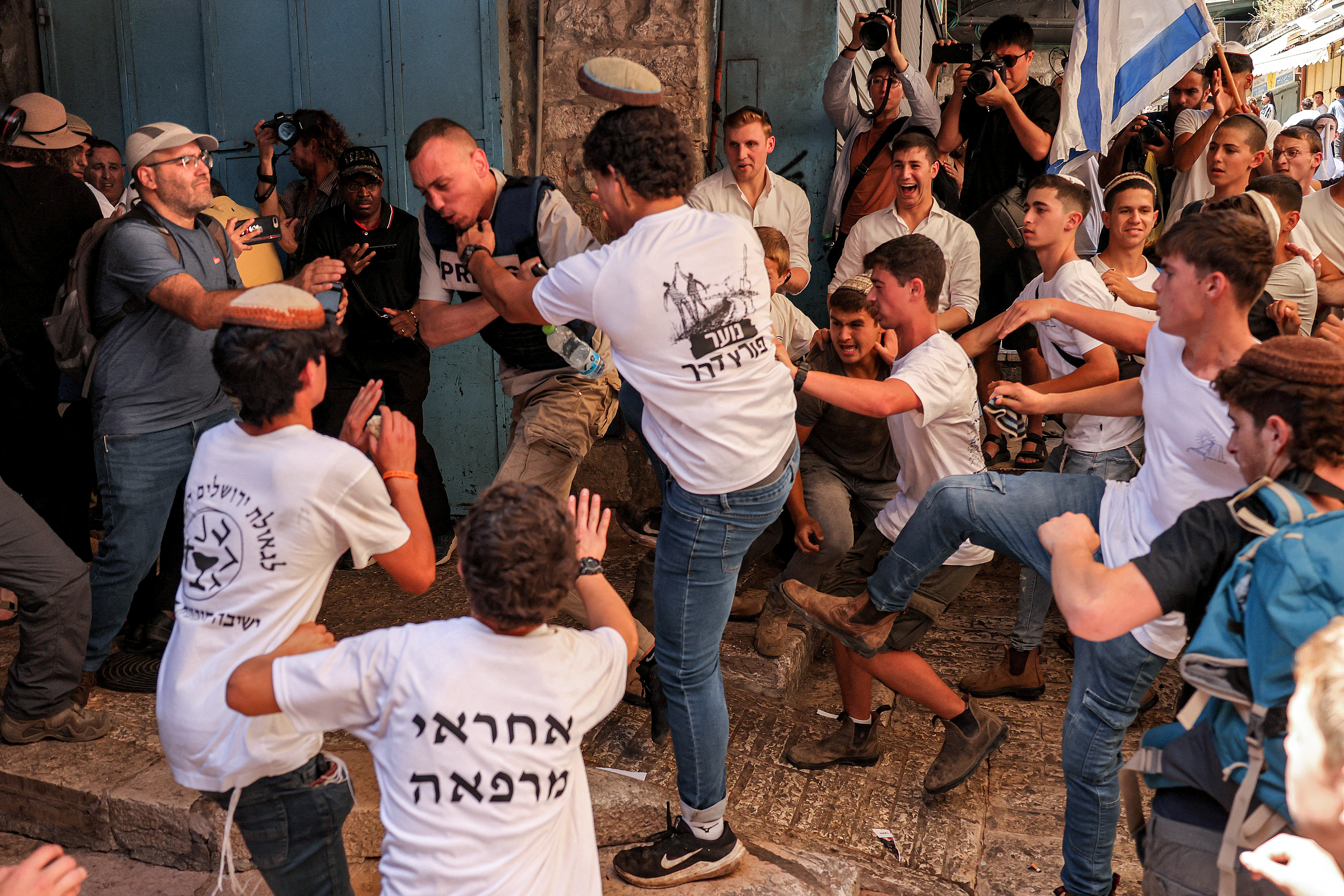 Israelis march through the alleyways of Jerusalem's Old City to the Western Wall, waving Israeli flags on 'Jerusalem Day' to commemorate the establishment of Israeli control over the city.