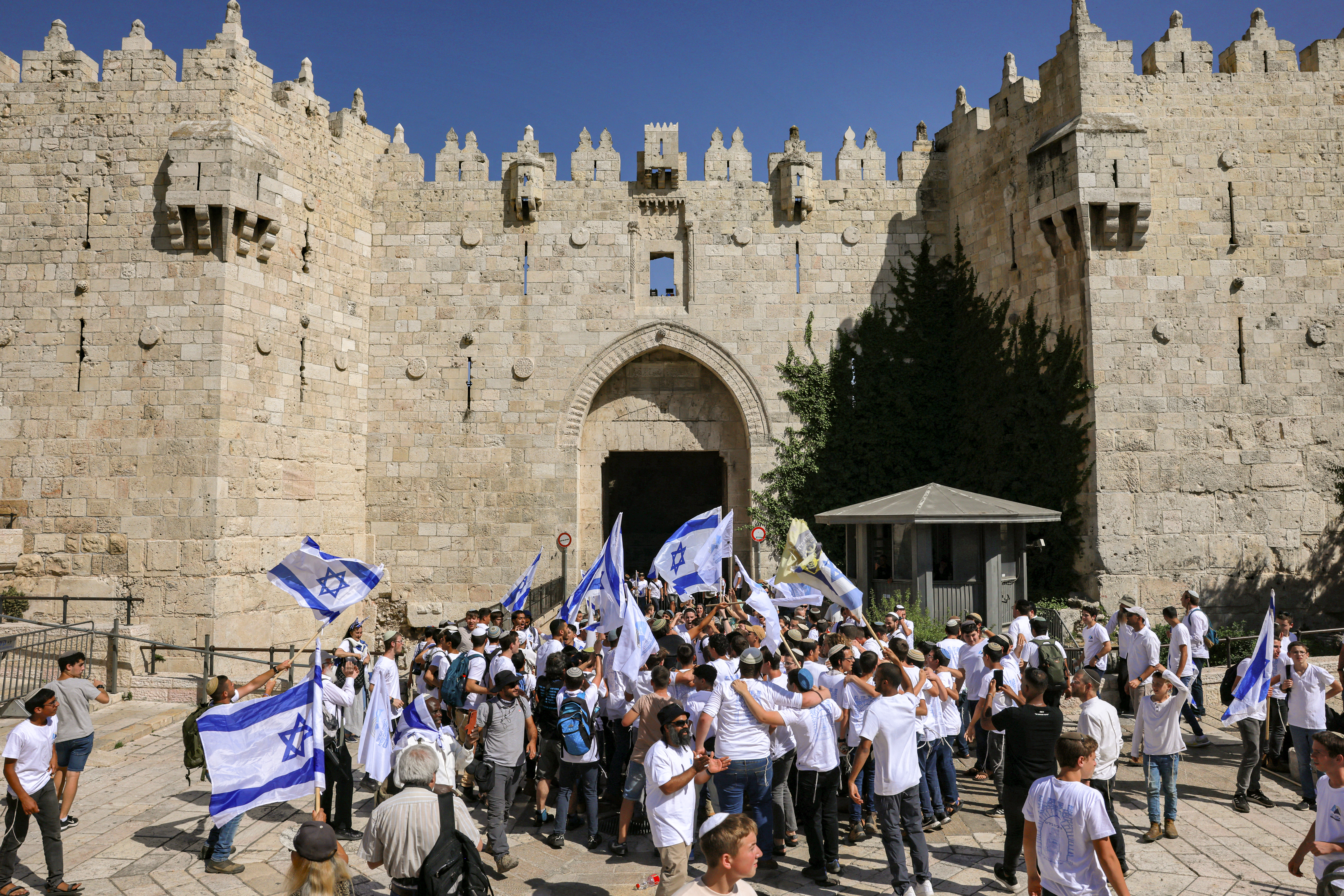 Israelis march through the alleyways of Jerusalem's Old City to the Western Wall, waving Israeli flags on 'Jerusalem Day' to commemorate the establishment of Israeli control over the city.