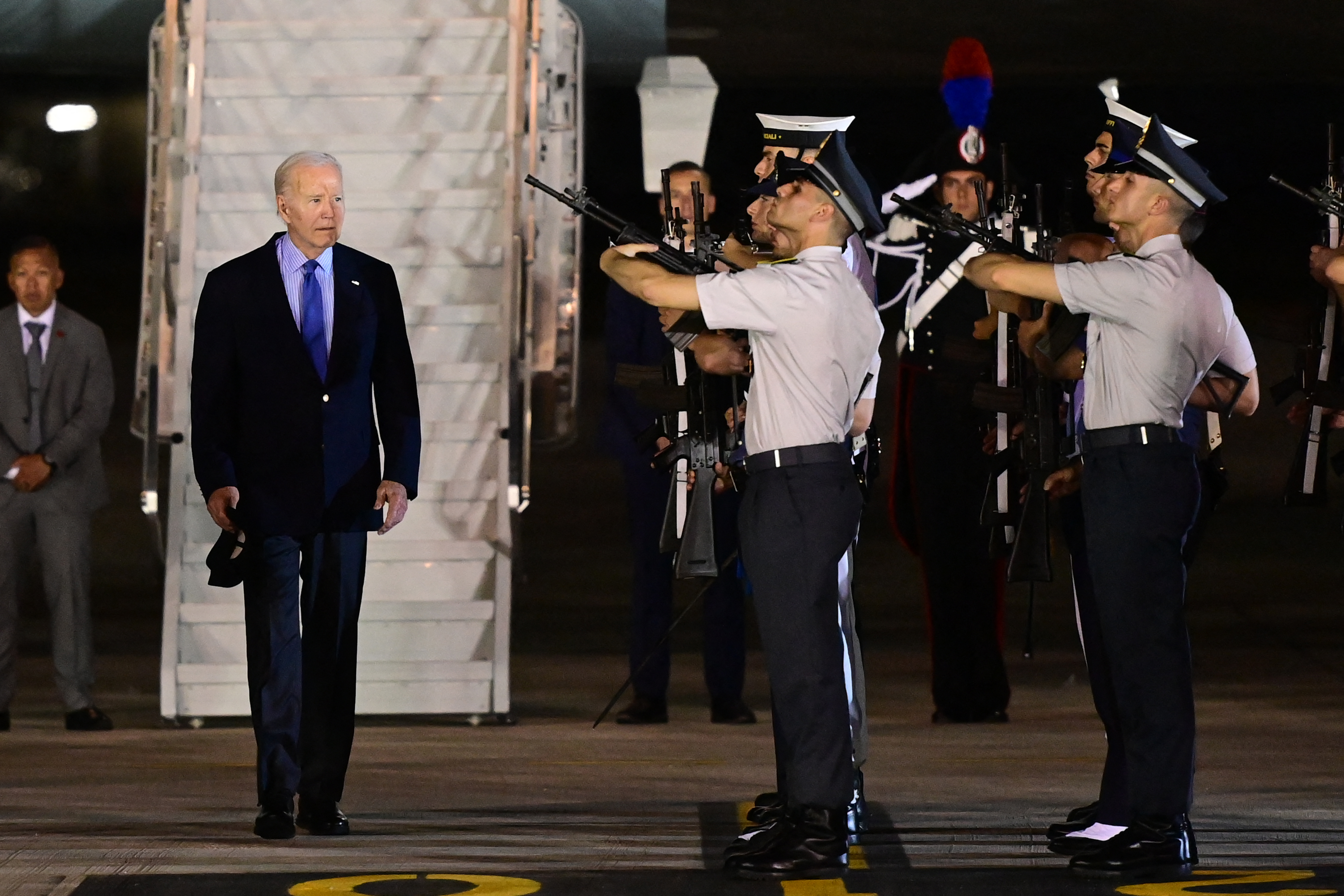 US President Joe Biden arriving at the airport in Brindisi. There is an honour guard to welcome him.