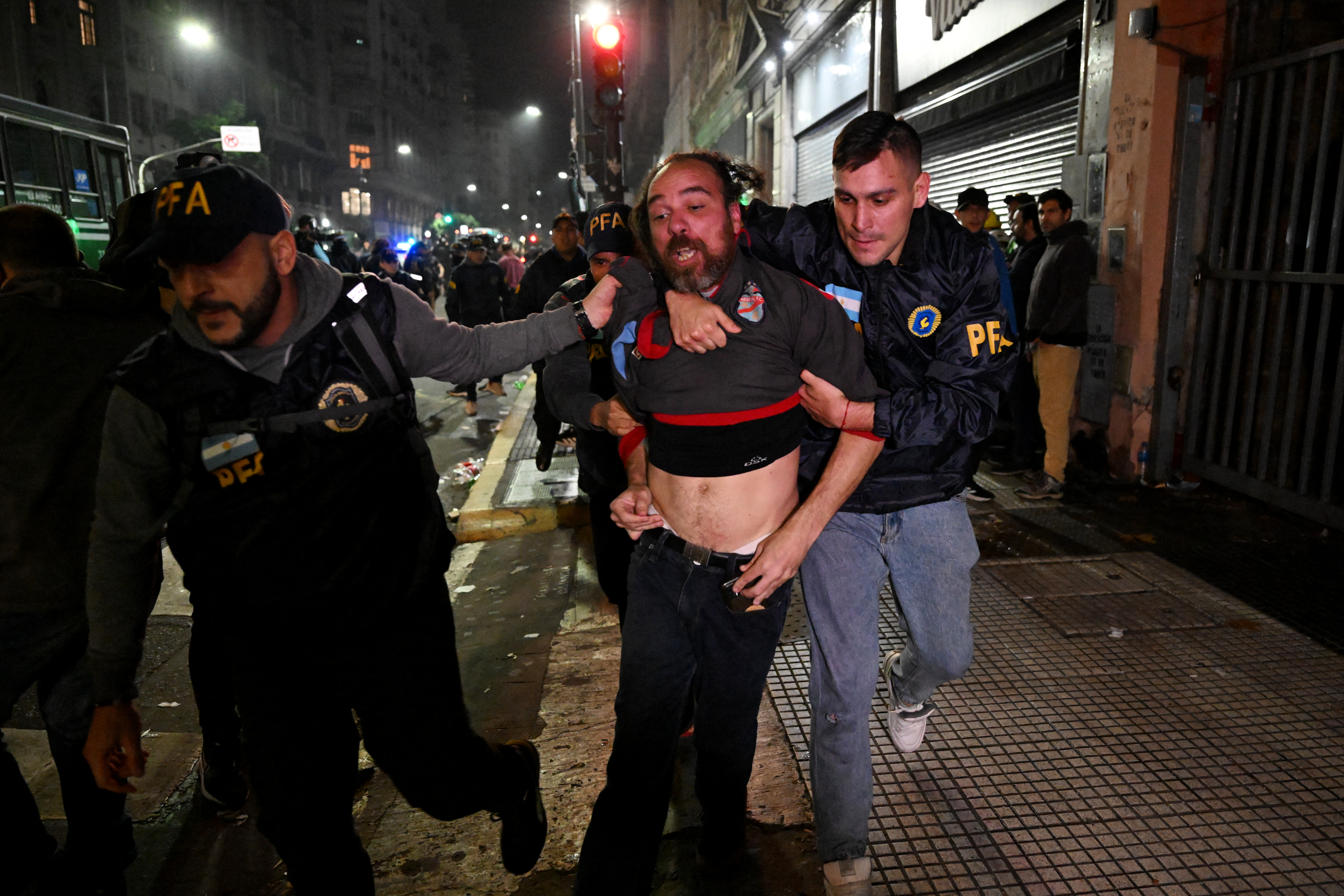 Police officers detain demonstrators during a protest in Buenos Aires