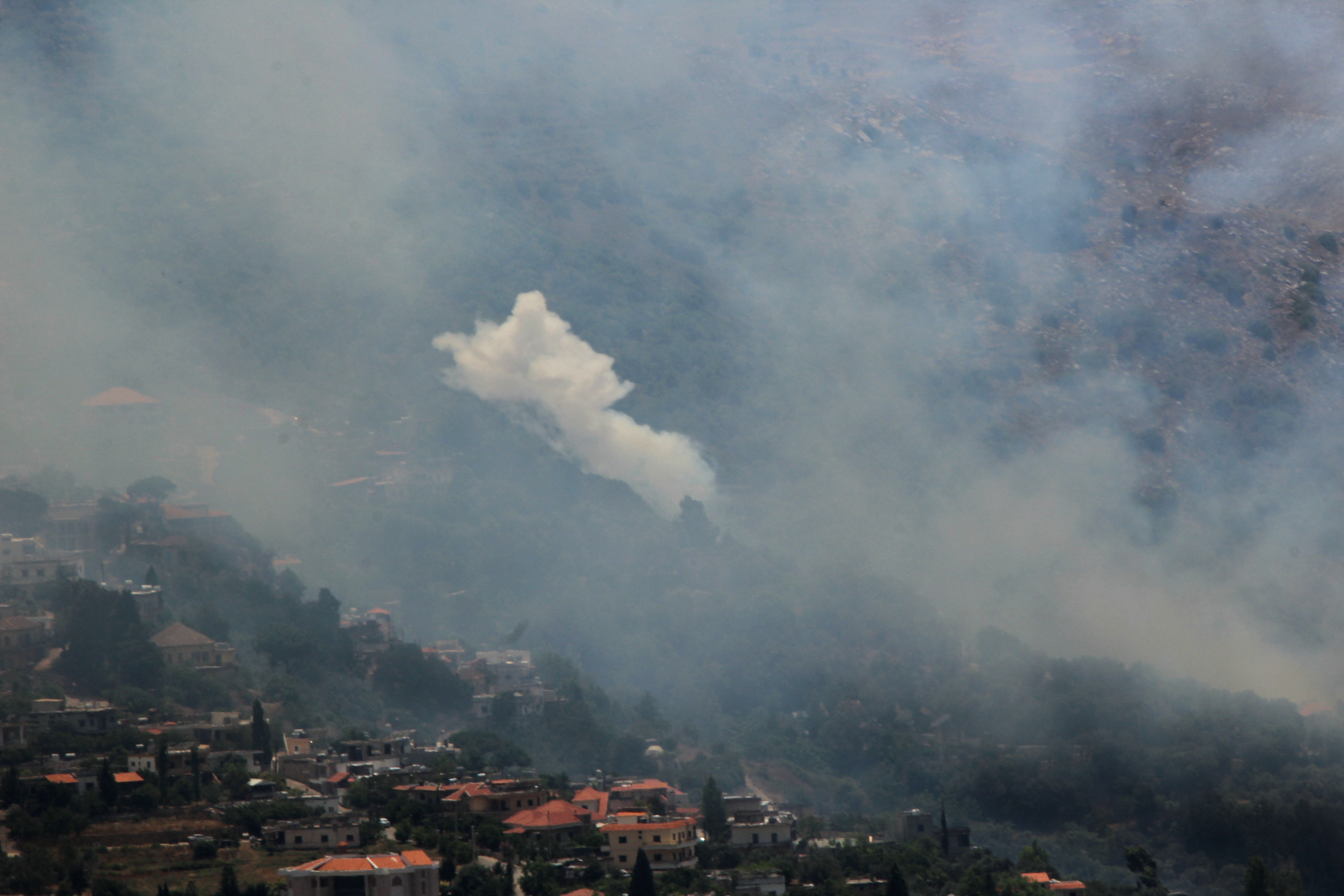 Smoke billows from fires ignited by Israeli shelling on the forested areas of the southern Lebanese village of Deir Mimas on June 15