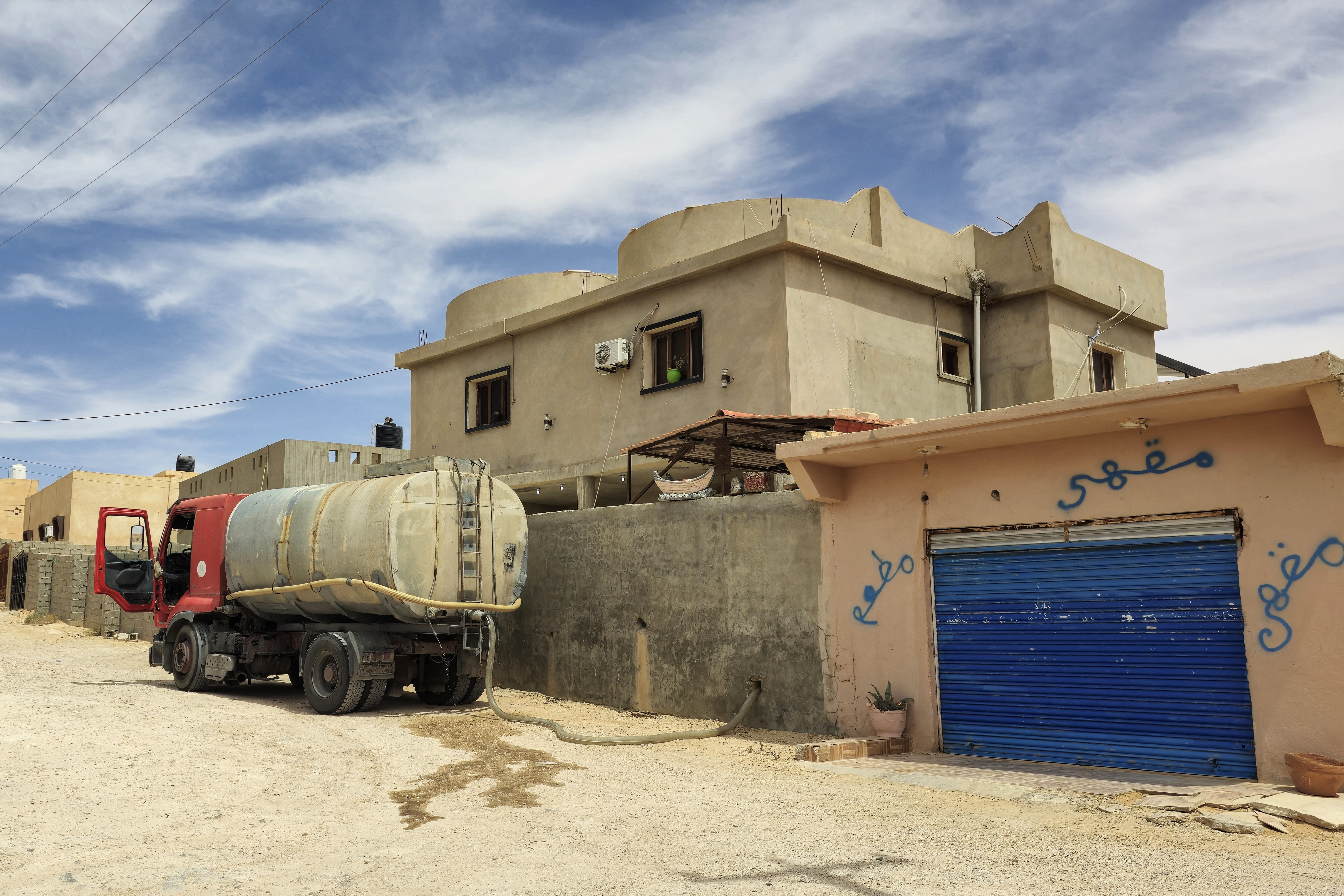 A tanker delivers water drawn from a well, to an inhabitant of the libyan village of Kabao in the Nafusa mountains