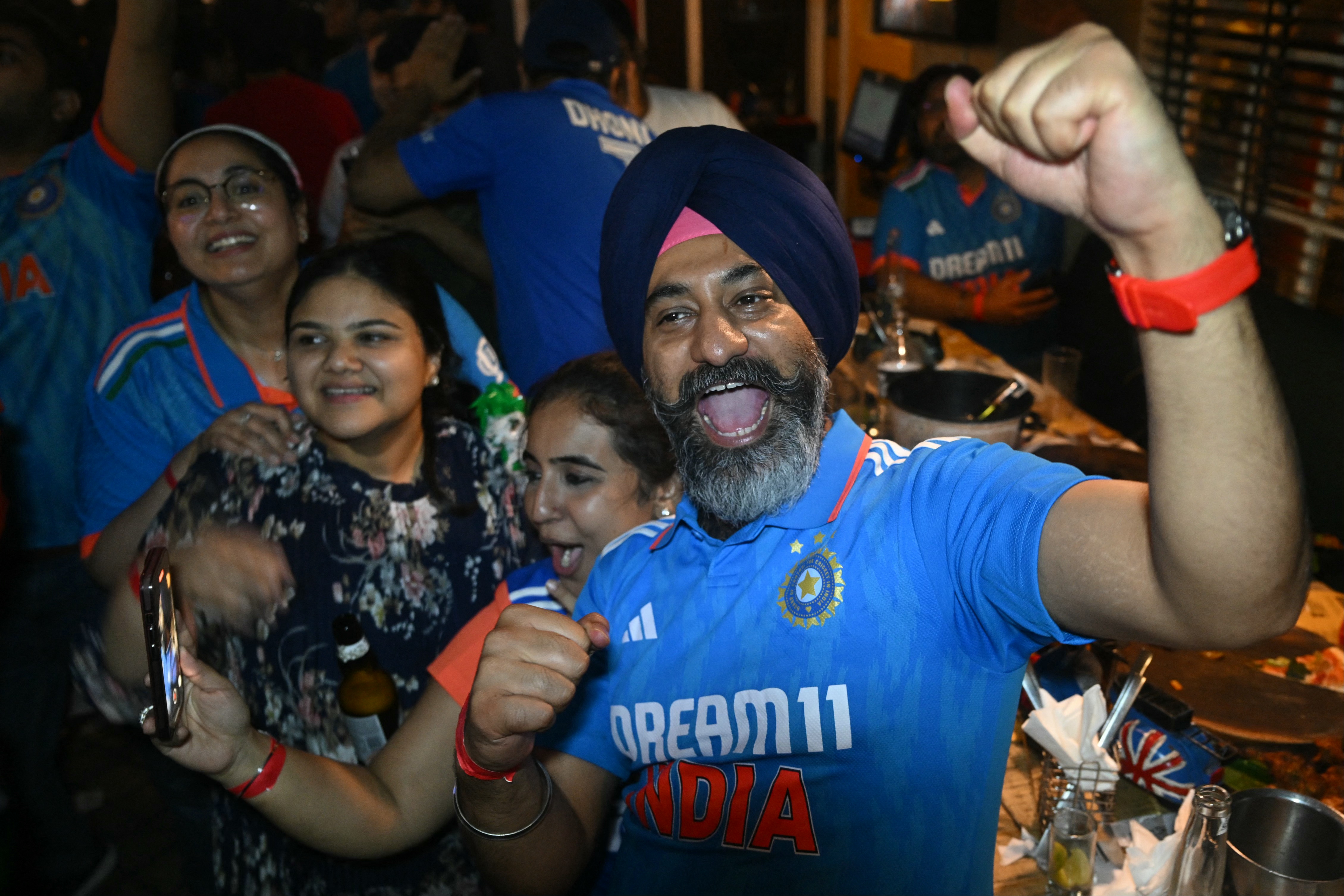 Fans celebrate after India wins the ICC Men's T20 World Cup final cricket match against South Africa, in New Delhi on June 29