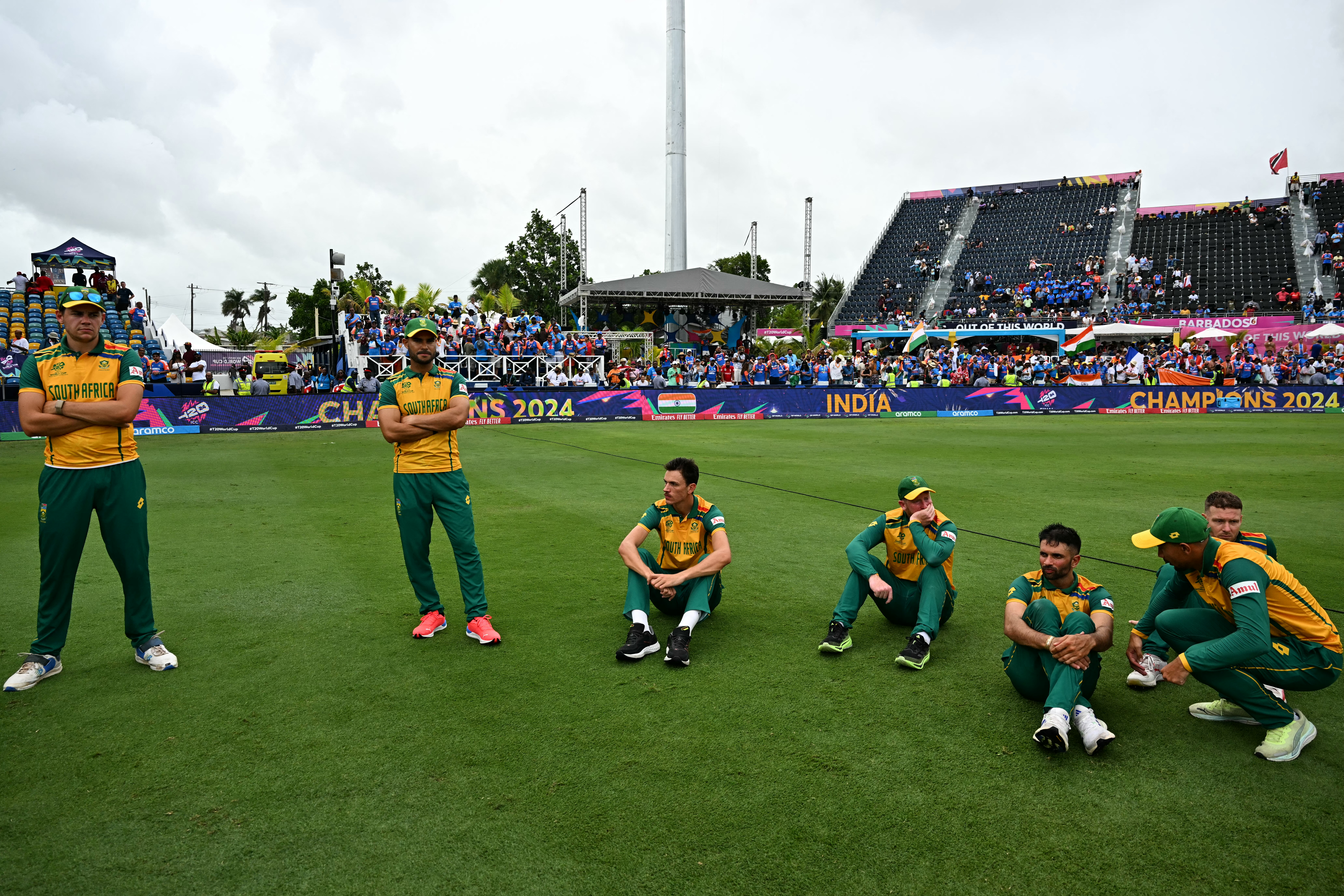 South African players wait on the field after losing the ICC men's Twenty20 World Cup 2024 final cricket match between India and South Africa at Kensington Oval in Bridgetown, Barbados, on June 29, 2024. (Photo by CHANDAN KHANNA / AFP)