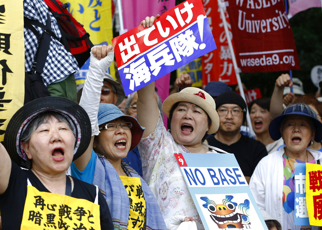 Anti-US base demonstrators shout slogans at a rally in front of the National Diet building in Tokyo as tens of thousands of Japanese protested against the presence of US military bases in Okinawa