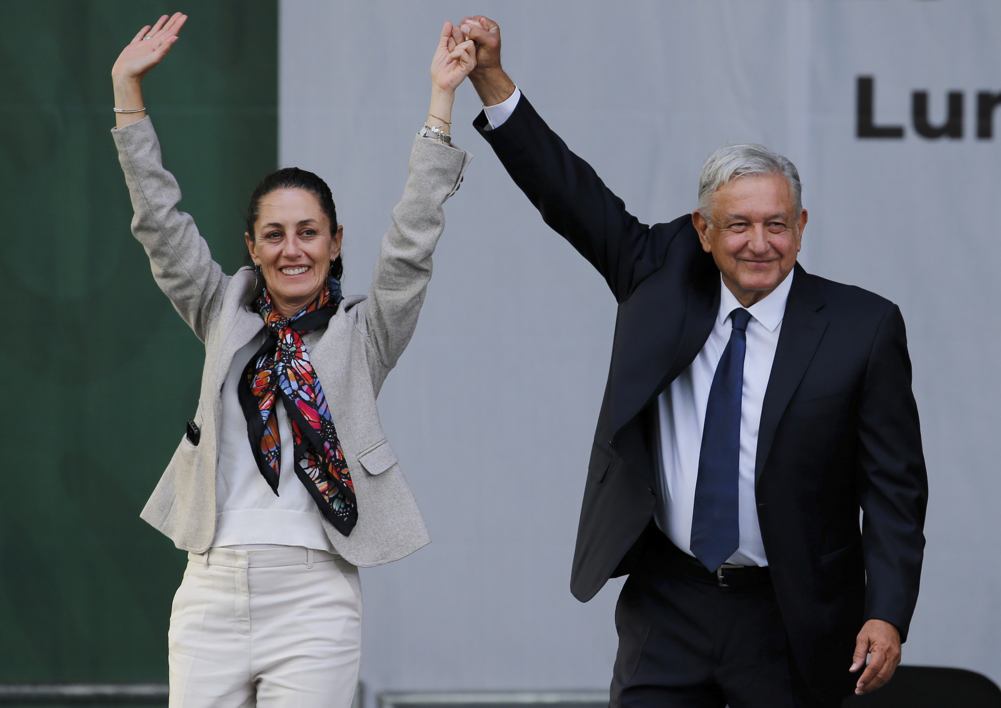 FILE - Mexico's President Andres Manuel Lopez Obrador, right, and Mayor Claudia Sheinbaum, greet supporters at a rally in Mexico City's main square, the Zocalo, July 1, 2019. Immigration is not part of Mexico's political conversation as the country gears up for its presidential vote on June 2 [Fernando Llano/AP]