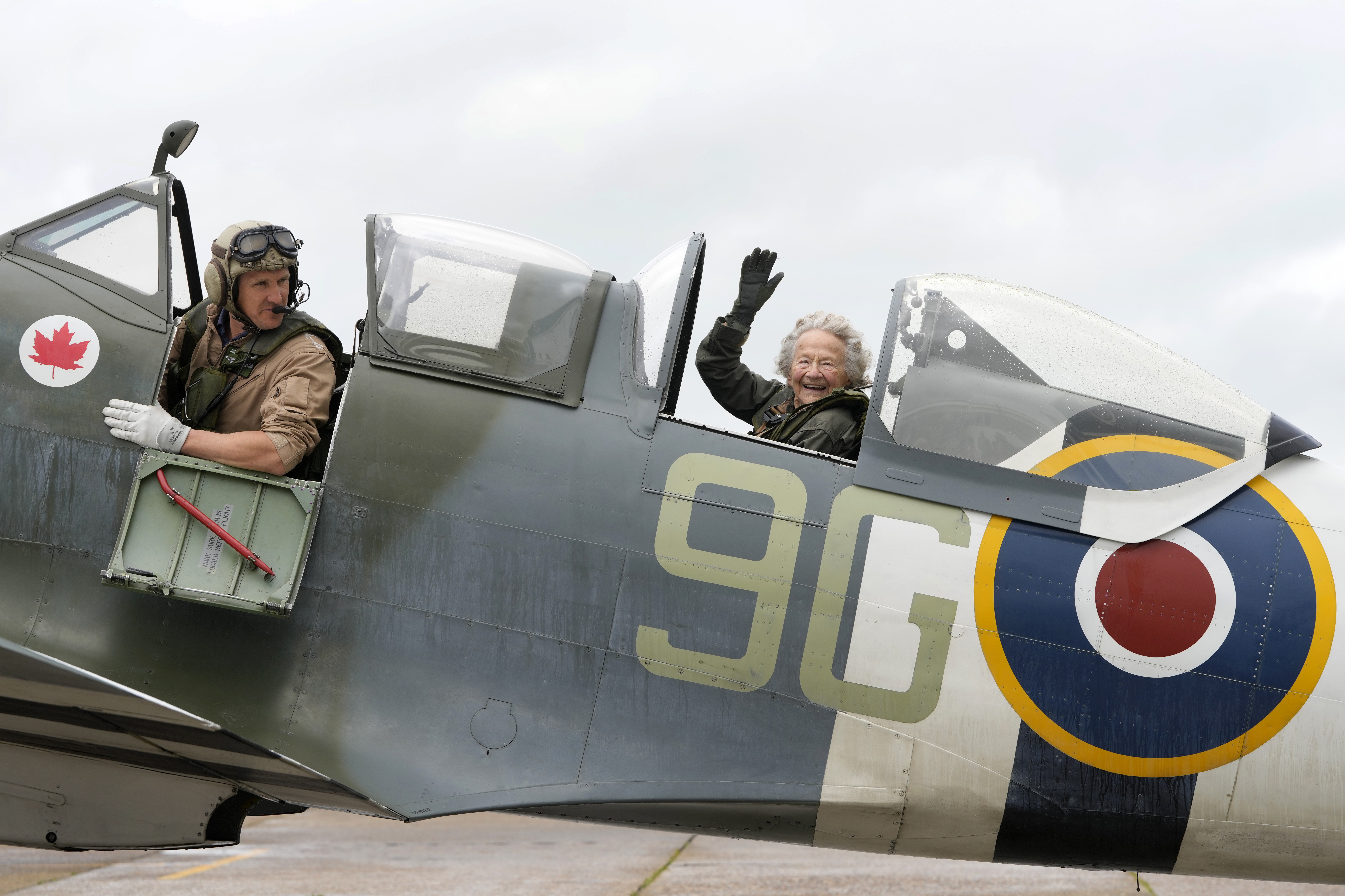 Dorothea Barron, aged 99, who was a serving Wren at the time of D-Day sits in a Spitfire with pilot Jeremy Britcher at Biggin Hill Airport in Kent, England, Tuesday, May 28