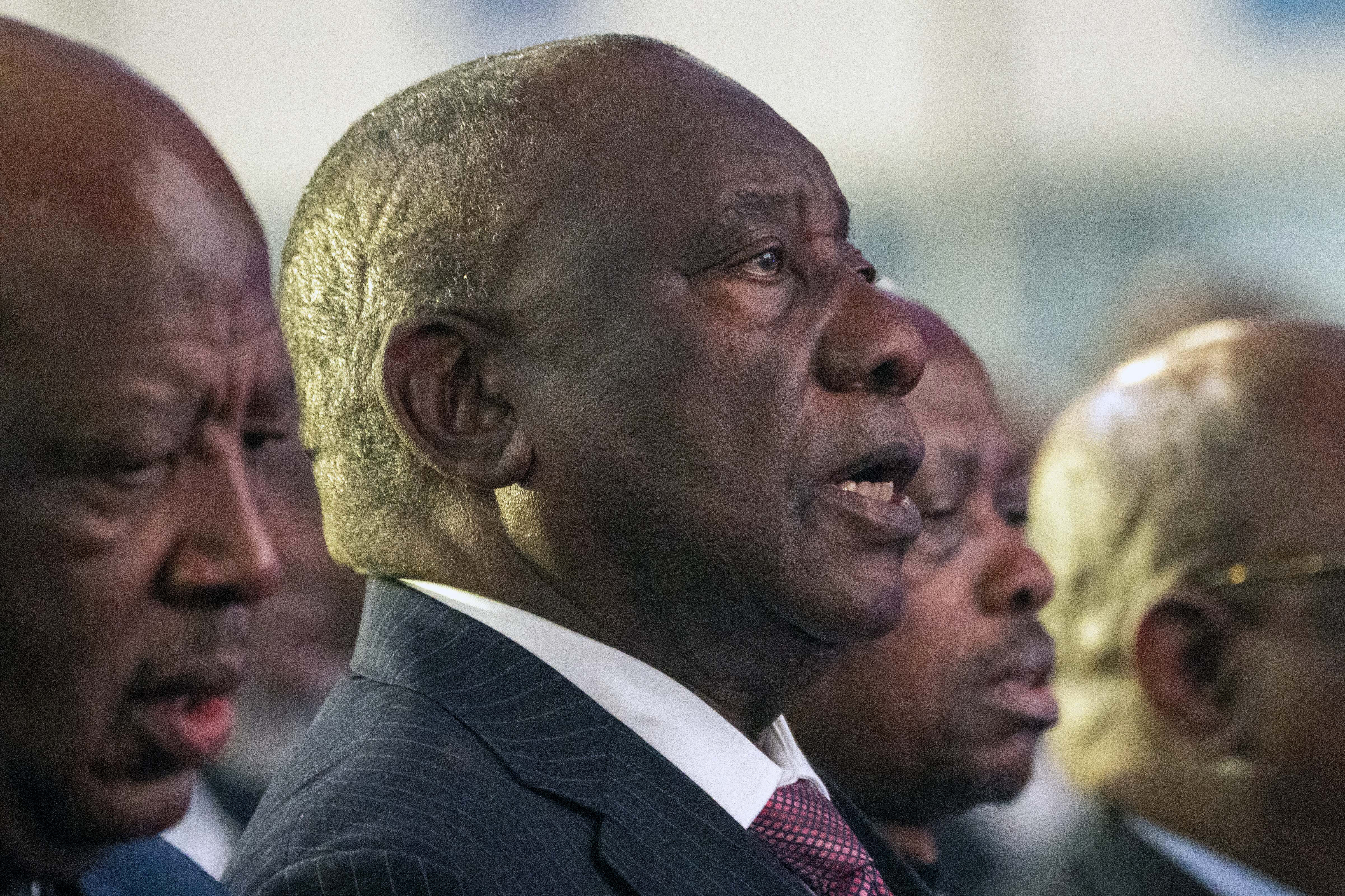 South African President Cyril Ramaphosa sings the national anthem at the formal announcement of the results in South Africa's general elections at the National Results Operations Center in Johannesburg, South Africa, Sunday, June 2, 2024. Humbled by a stinging election result, South Africa's African National Congress was talking to everyone in an effort to form a stable coalition government for Africa's most advanced economy after it lost its 30-year majority. (AP Photo/Jerome Delay)