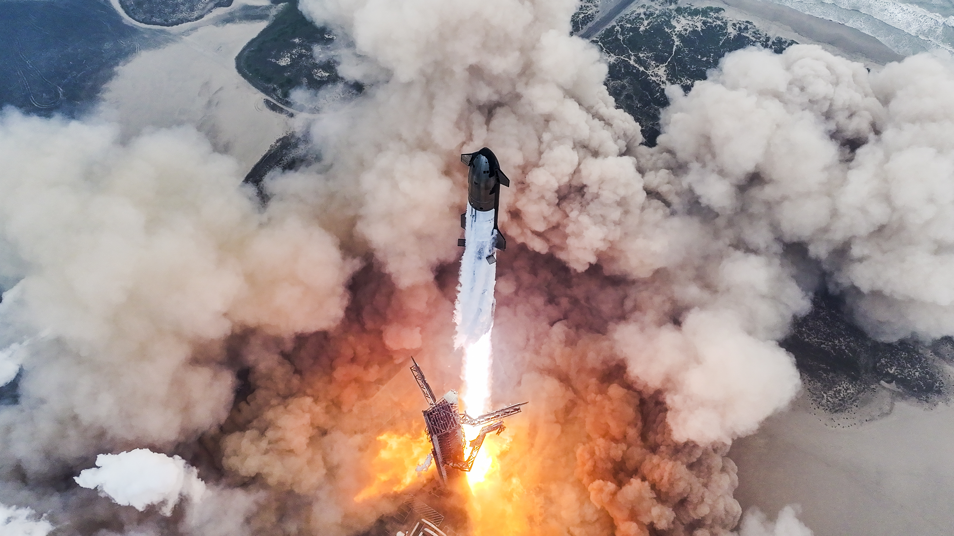 Starship taking off from Texas in clouds of smoke and flame