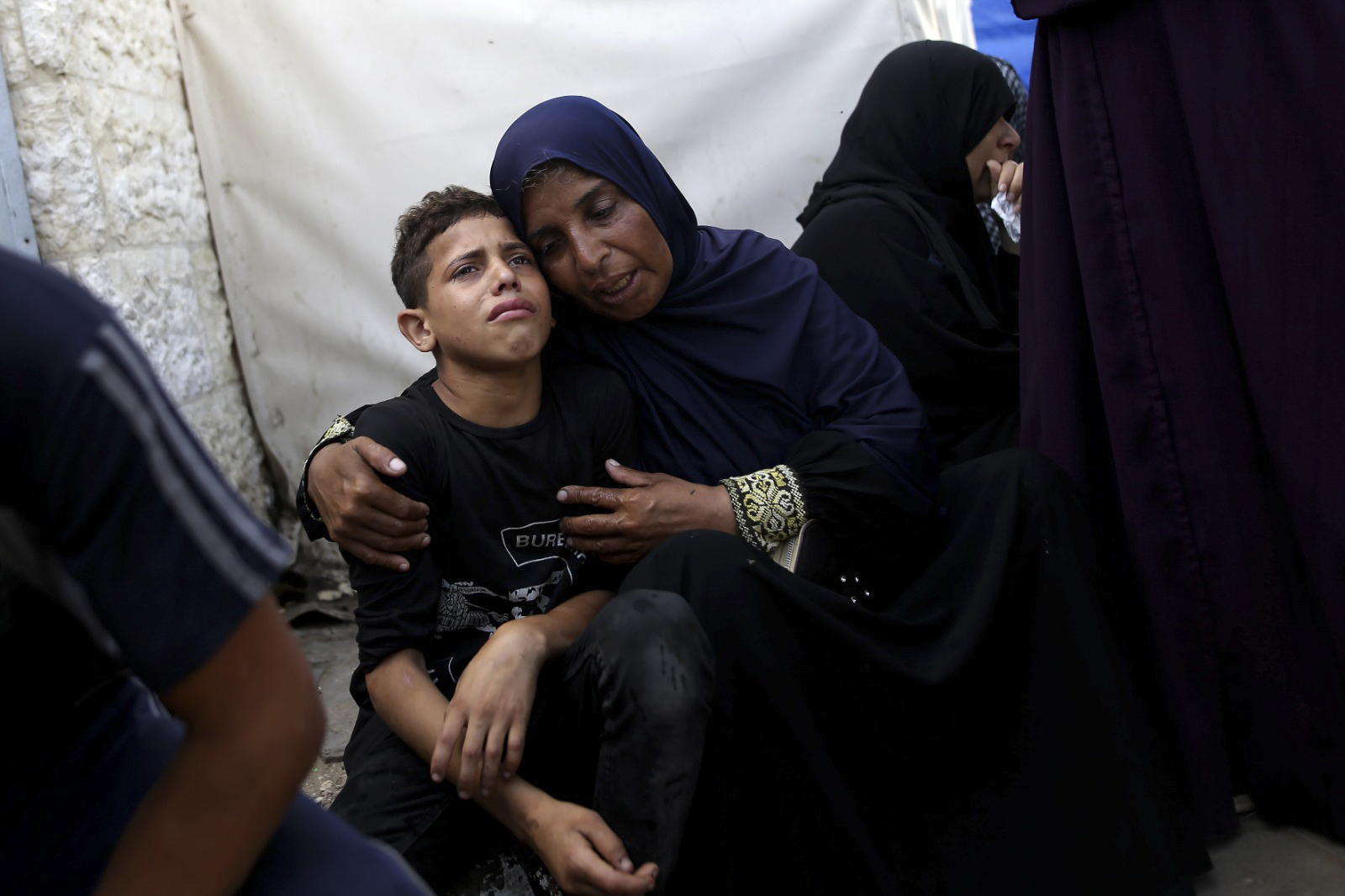 Palestinians mourn their relatives killed in the Israeli bombardment of the Gaza Strip at al-Aqsa Hospital in Deir al-Balah, central Gaza Strip, Saturday, June 8