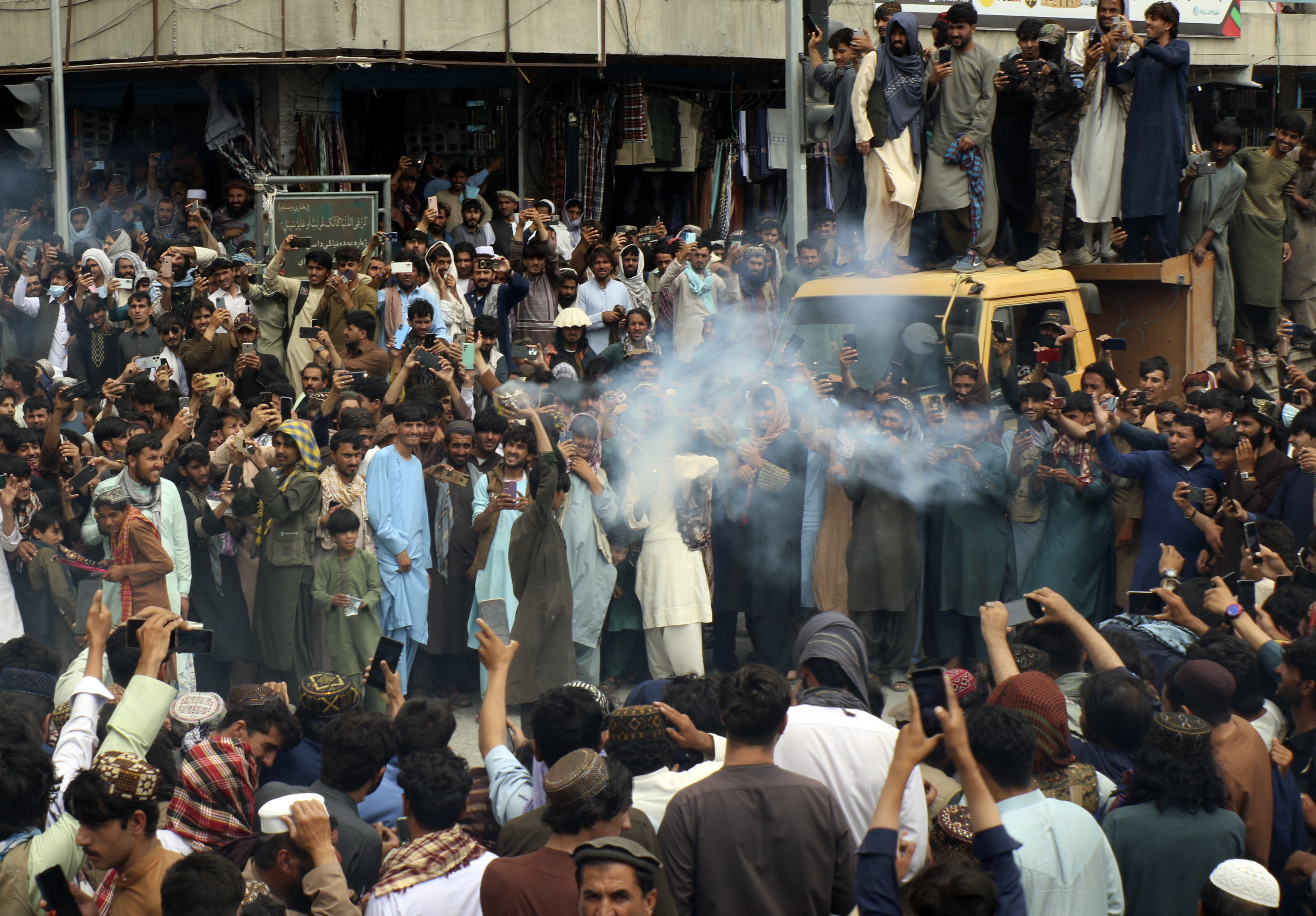 Afghan cricket fans celebrate their team's victory during the men's T20 World Cup cricket match between Afghanistan and Bangladesh, in the city of Khost province eastern of Afghanistan, Tuesday, June. 25, 2024. Afghanistan edged Bangladesh to reach the Twenty20 World Cup semifinals for the first time and followed India into the last four following a combination of results that eliminated 2021 champion Australia on Monday. (AP Photo/Saifullah Zahir)
