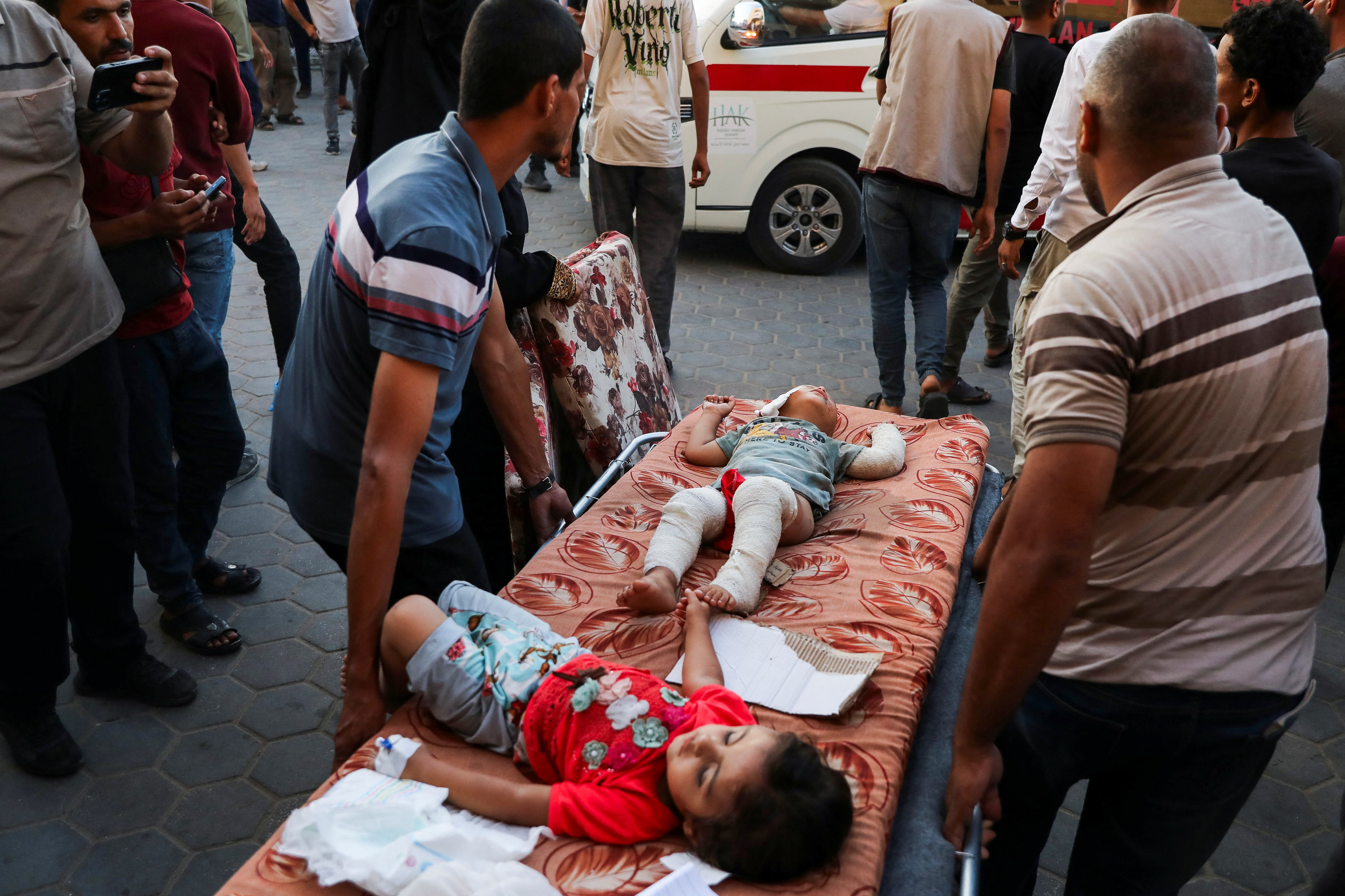 Wounded Palestinian children are carried on stretchers, after an Israeli strike, amid the Israel-Hamas conflict, at Al-Aqsa Martyrs Hospital in Deir Al-Balah, in the central Gaza Strip, June 9, 2024