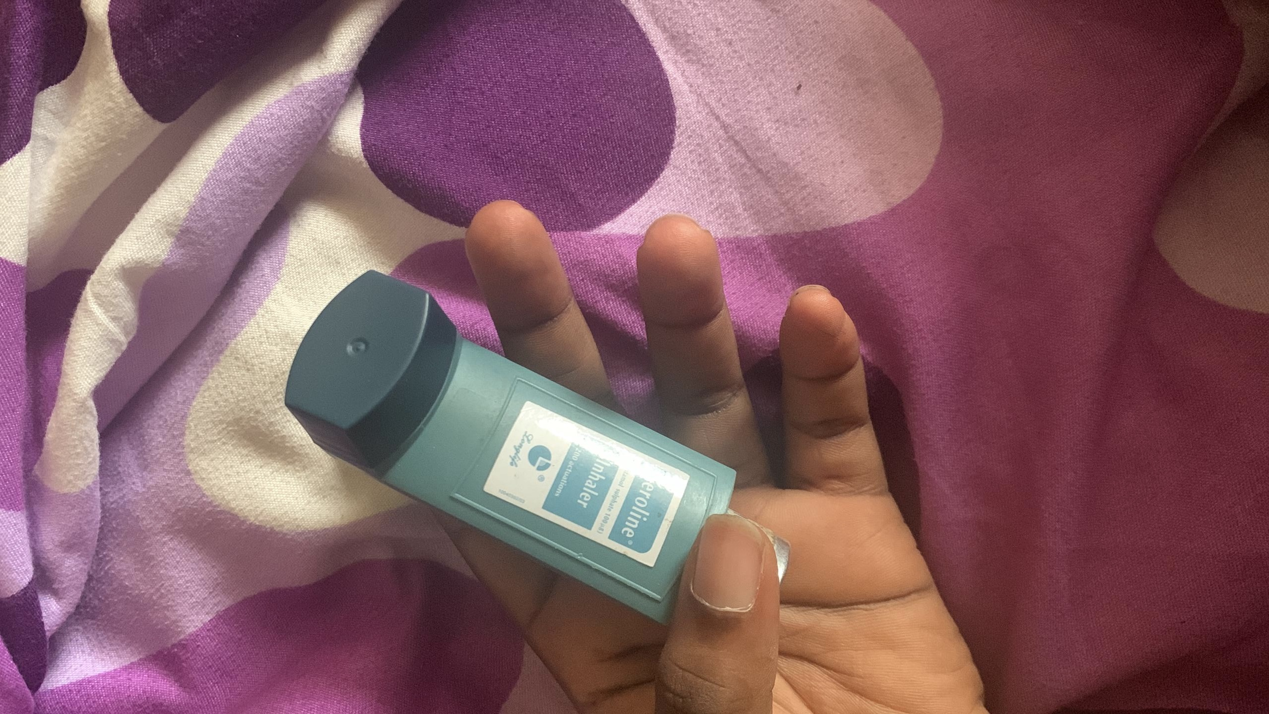 An asthma patient holds an inhaler