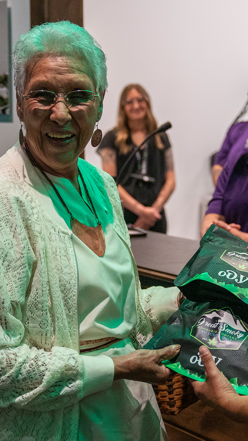 Myrtle Driver and another member of the Eastern Band of Cherokee Indians hold up a package of marijunana infused edibles, labelled in the traditional Cherokee language.