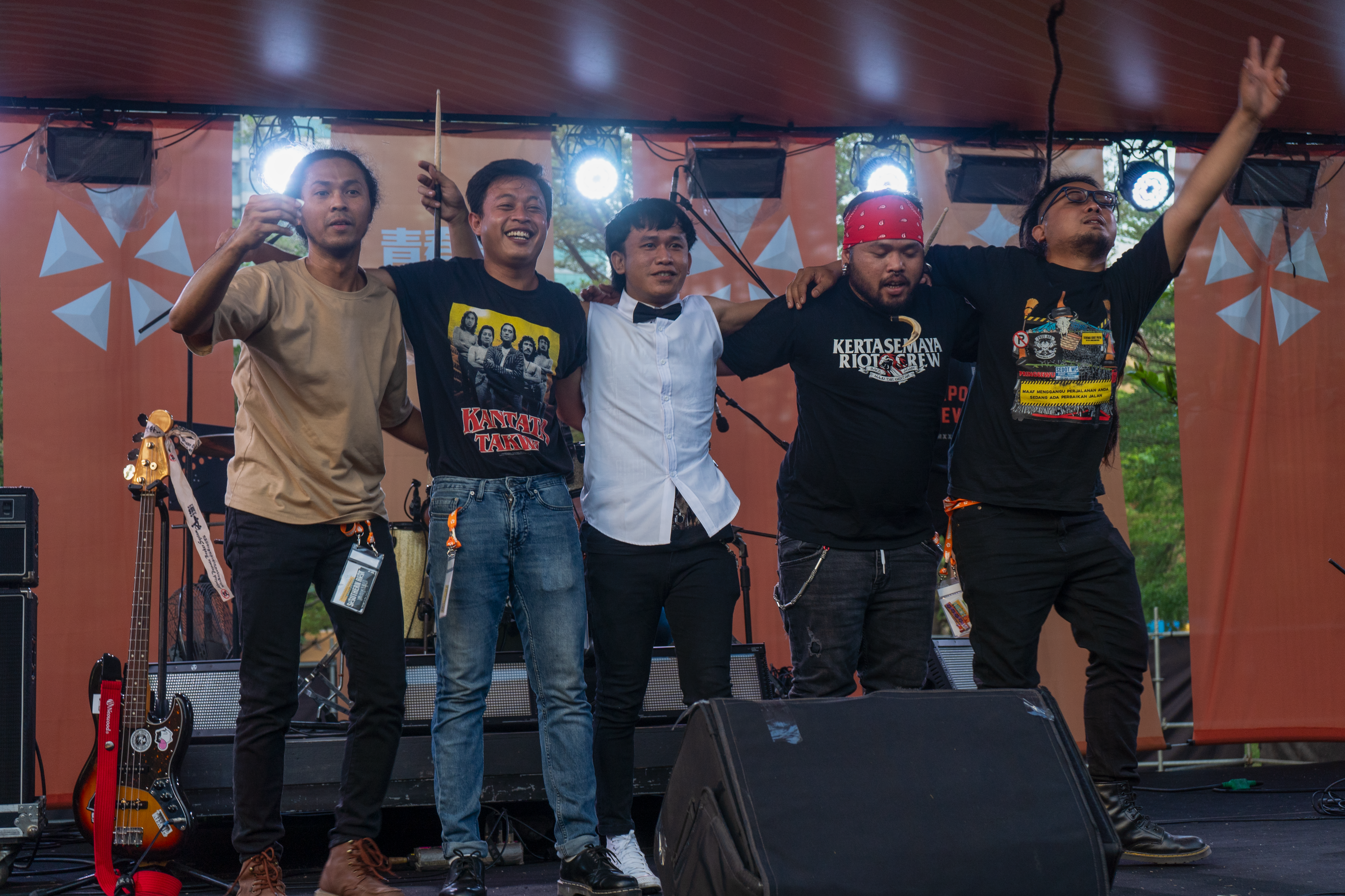 Southern Riot taking a bow. They are lined up on the stage. They look tired by happy