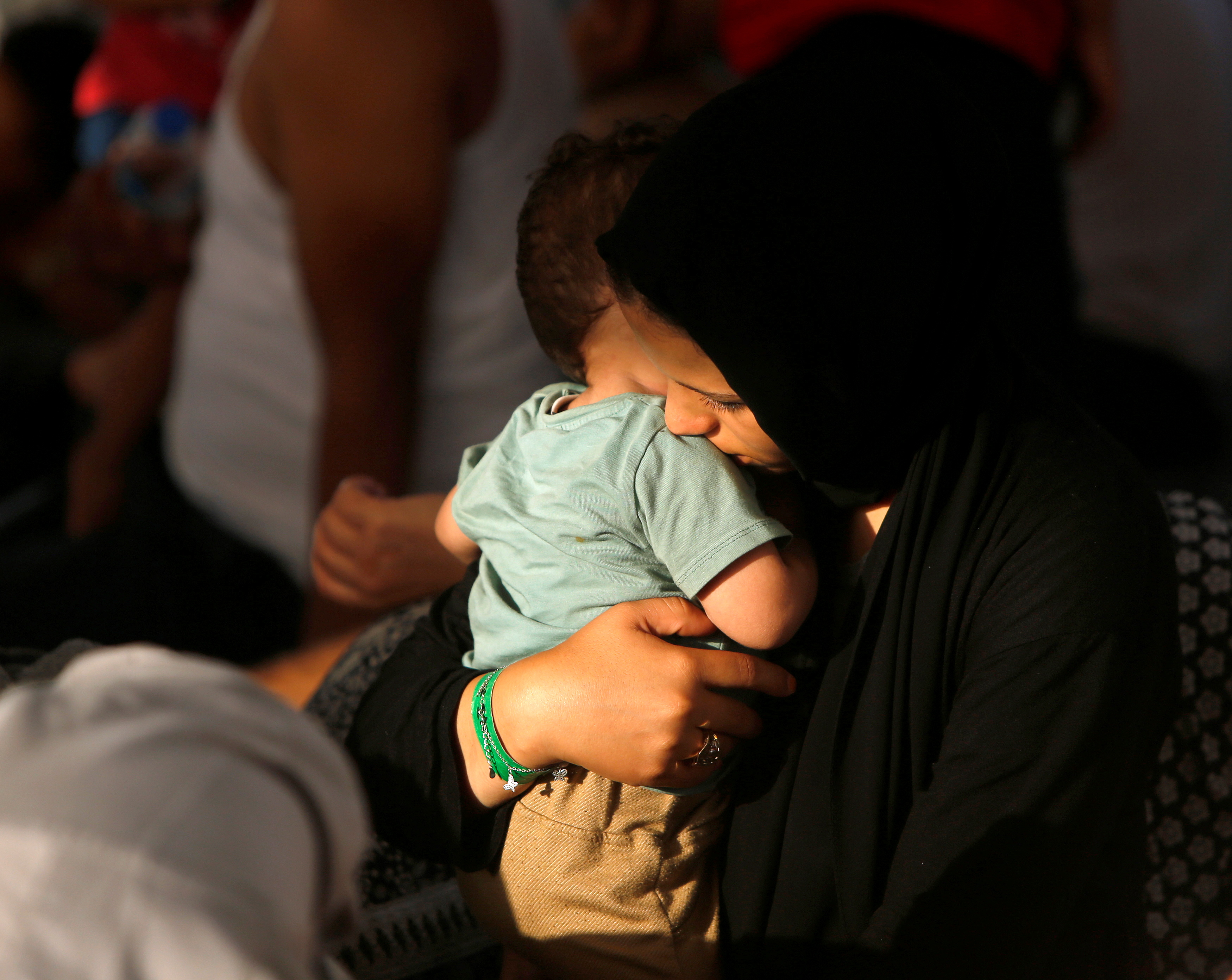 A migrant holds her baby on the German NGO migrant rescue ship Sea-Watch 3 in international waters north of Libya, in the western Mediterranean Sea, August 2, 2021. REUTERS/Darrin Zammit Lupi