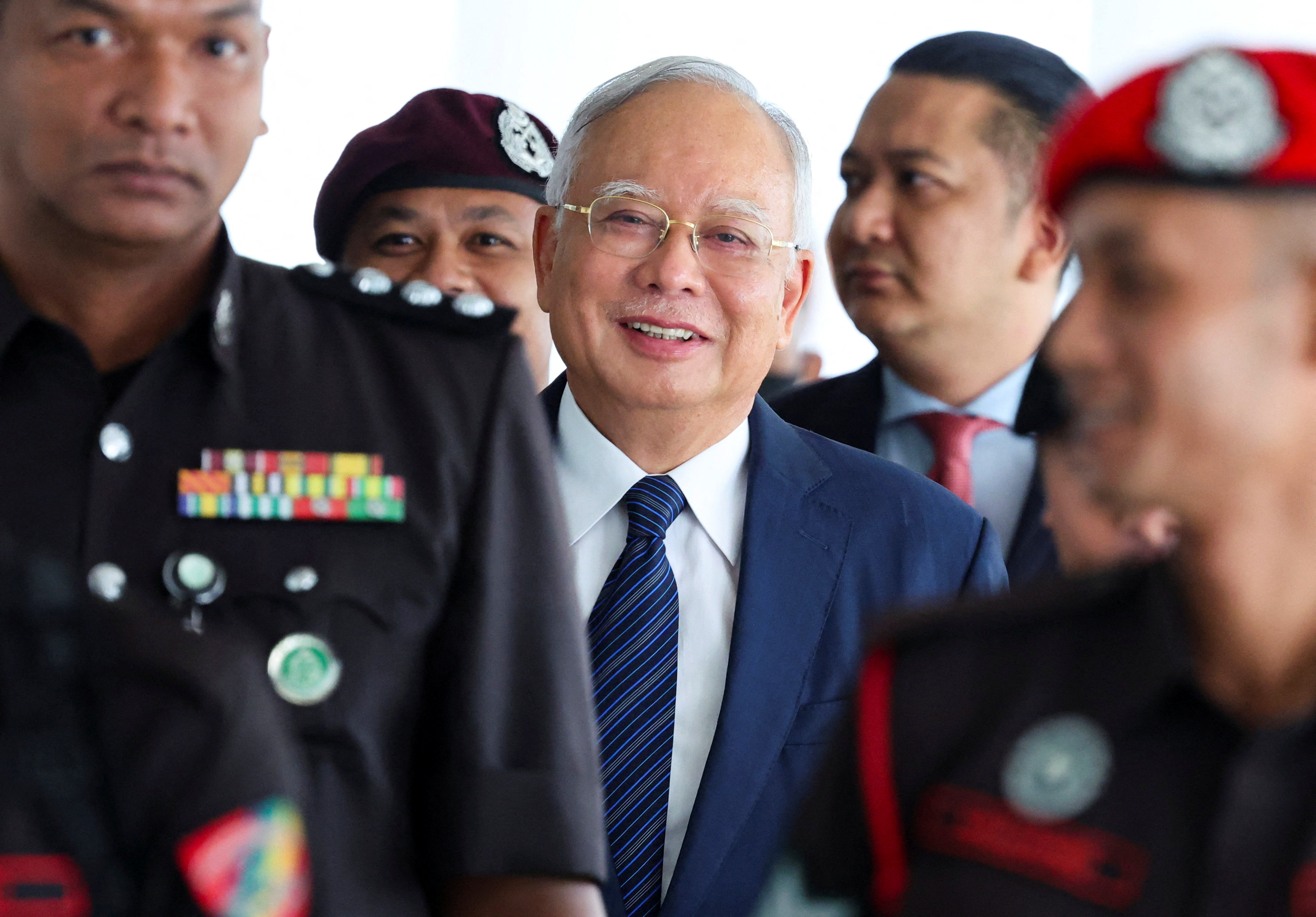 Prison officers escort former Malaysian Prime Minister Najib Razak, as the jailed politician leaves the court during a break in proceedings, in Kuala Lumpur, Malaysia, April 4, 2024.