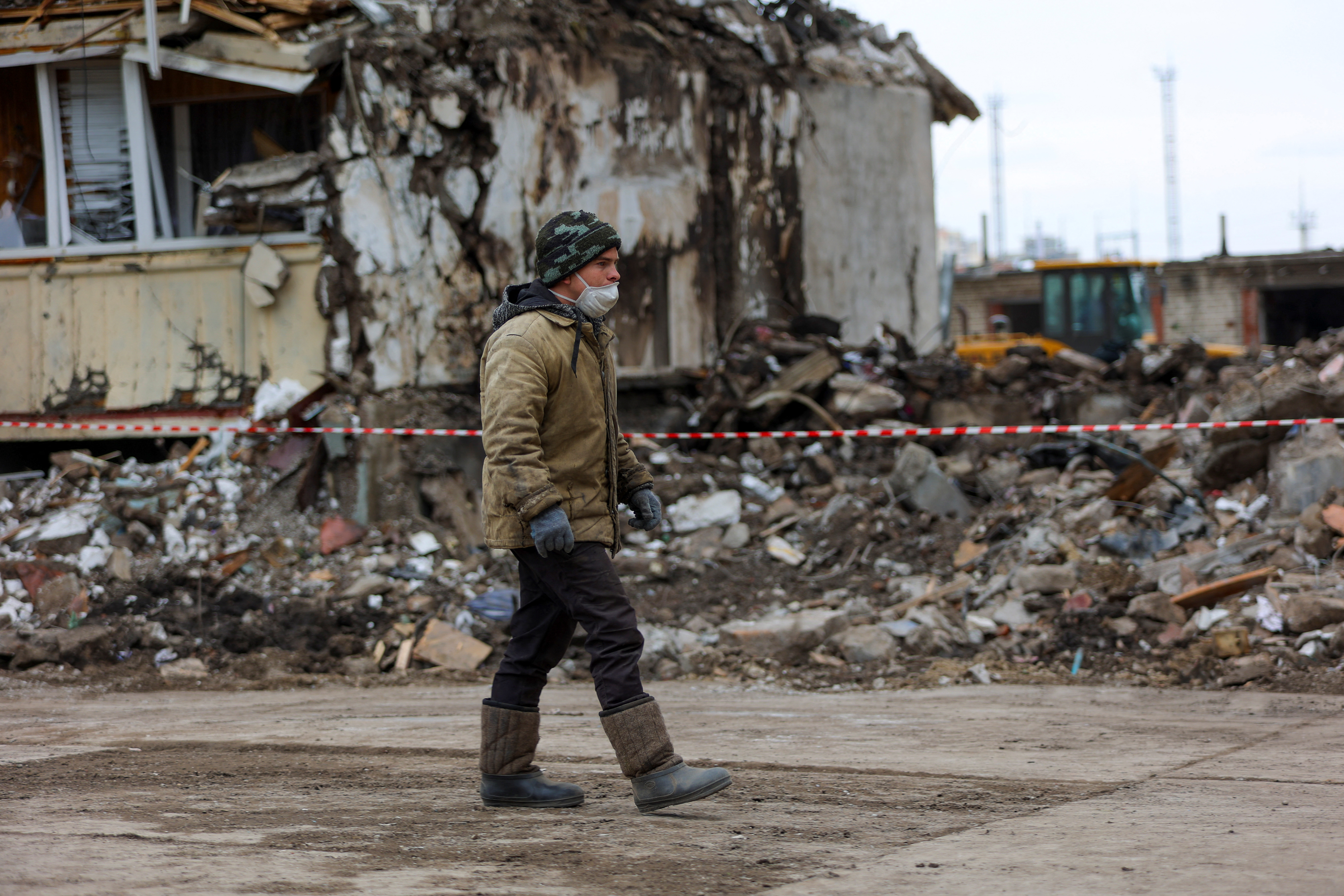 A worker walks while removing debris of a damaged multi-story apartment block, a section of which collapsed as the result of what local authorities called a Ukrainian missile strike, in the course of Russia-Ukraine conflict in the city of Belgorod, Russia, May 13, 2024. REUTERS/Stringer