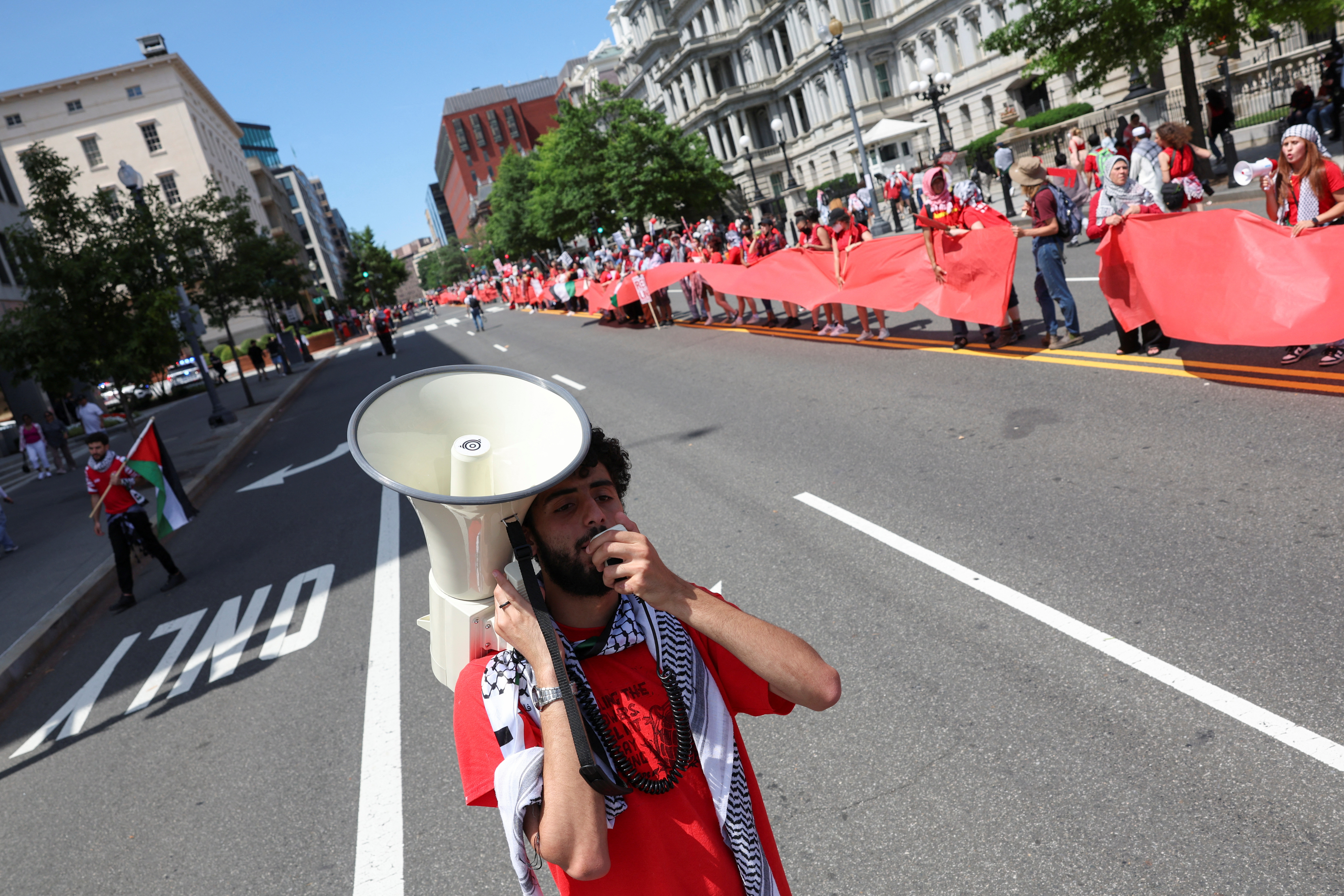 Demonstrators chant slogans outside the Eisenhower Executive Office Building, surrounding the White House grounds with a red banner symbolising President Biden's 'red line' about Israel going into Gaza's Rafah, during a pro-Palestinian protest, amid the Israel-Hamas conflict, in Washington, U.S., June 8, 2024. REUTERS/Tom Brenner