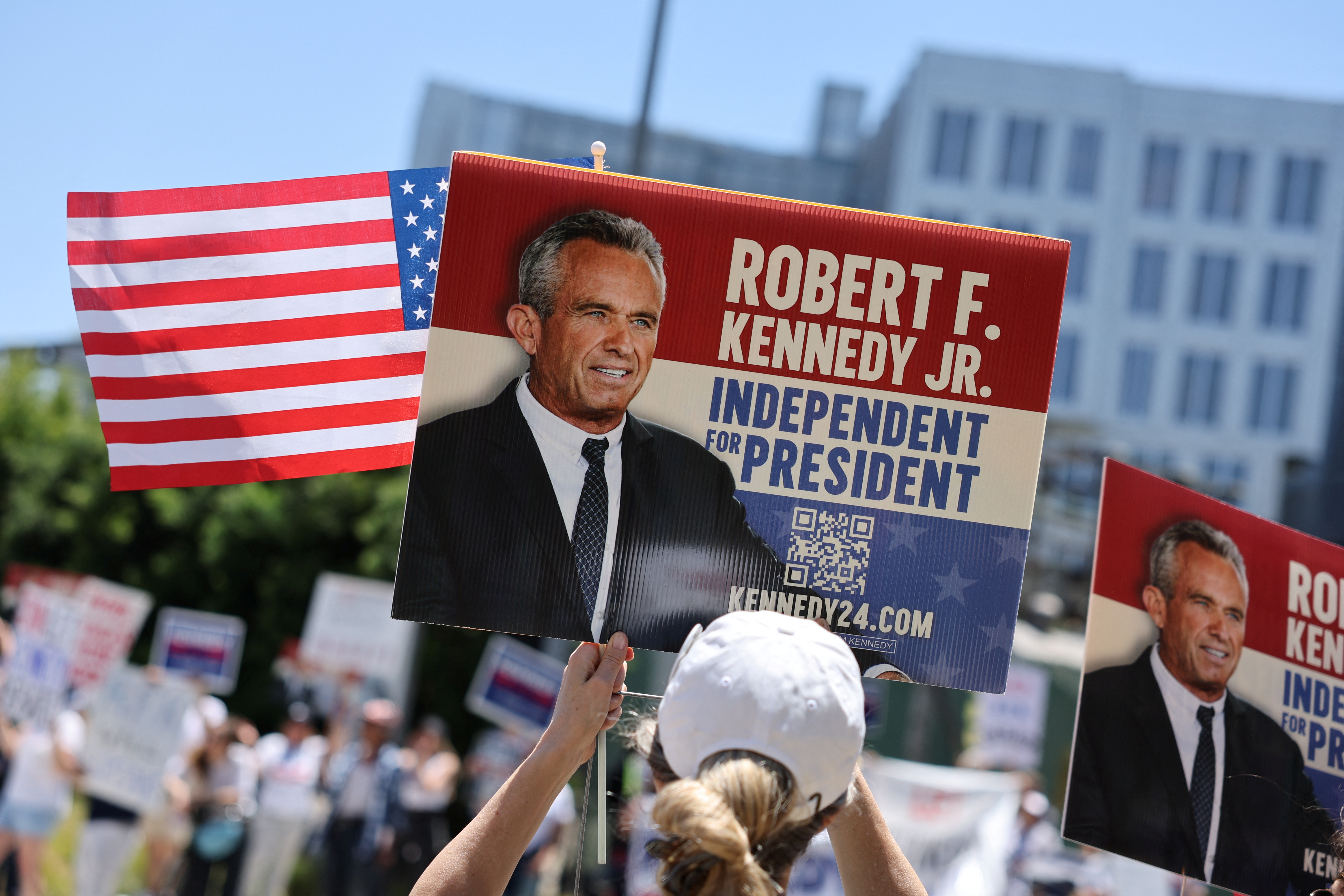 A demonstrator holds a sign, as volunteers and supporters of independent U.S. presidential candidate Robert F. Kennedy Jr protest against his exclusion from the first presidential debate