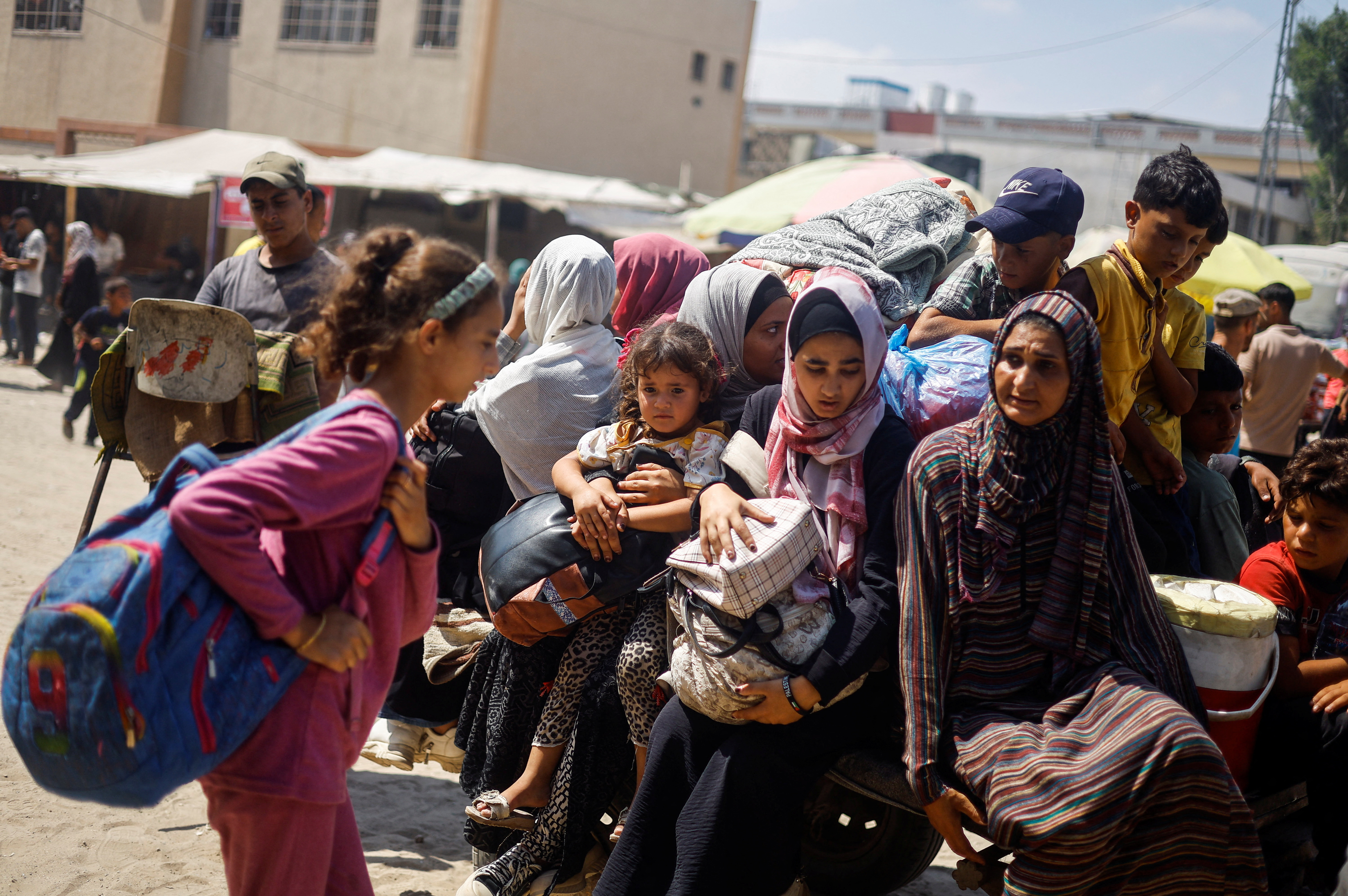 Palestinians, who fled the eastern part of Khan Younis after they were ordered by Israeli army to evacuate their neighborhoods, carry their belongings, amid Israel-Hamas conflict, in Khan Younis in the southern Gaza Strip July 2, 2024. REUTERS/Mohammed Salem