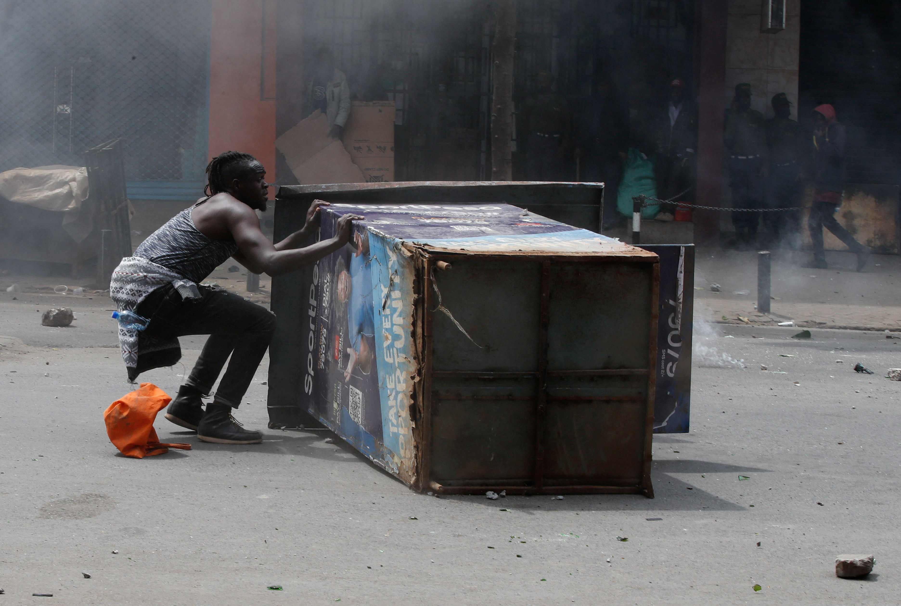 A protester reacts during a demonstration over police killings of people protesting against the imposition of tax hikes by the government, in Nairobi, Kenya,