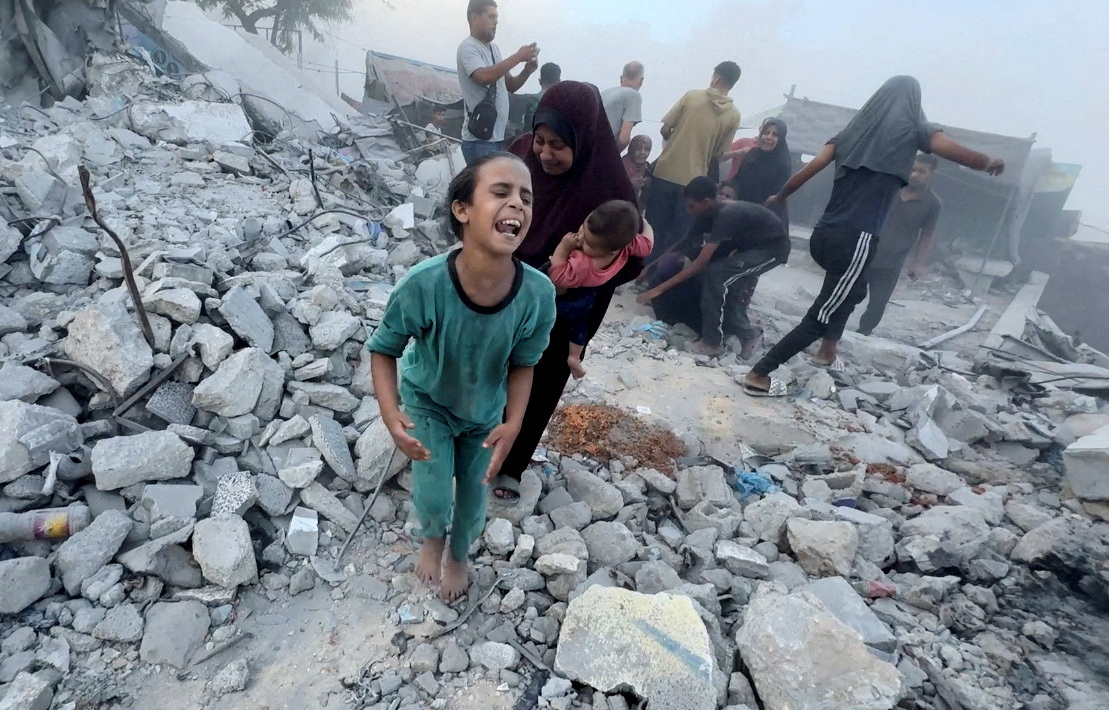 Palestinians react, following an Israeli strike near a UN-run school sheltering displaced people, amid the Israel-Hamas conflict, in Khan Younis, in the southern Gaza Strip, in this still image taken from a video, July 3, 2024. REUTERS/Mohammed Salem