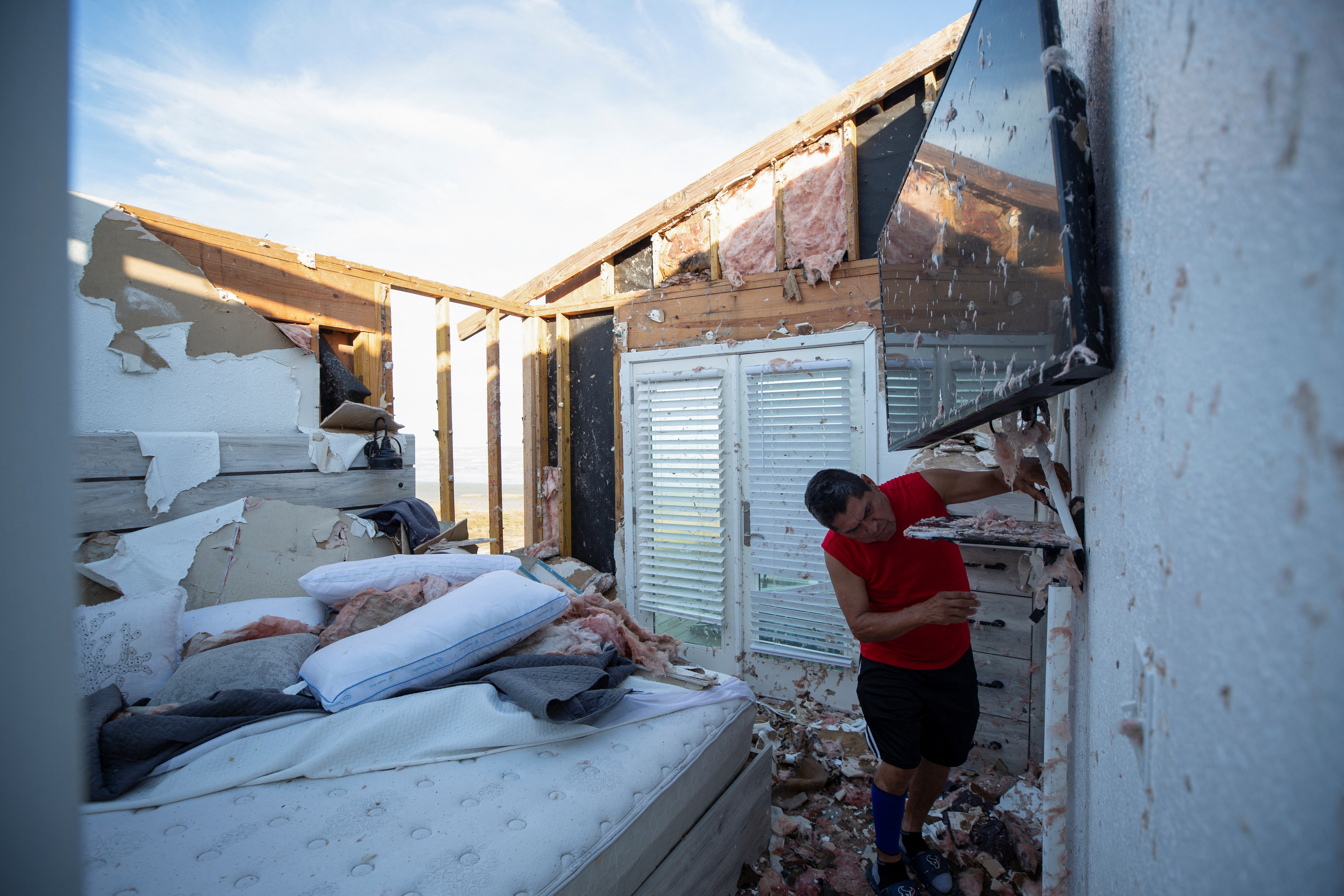 A man surveys damage from Hurricane Beryl in Texas