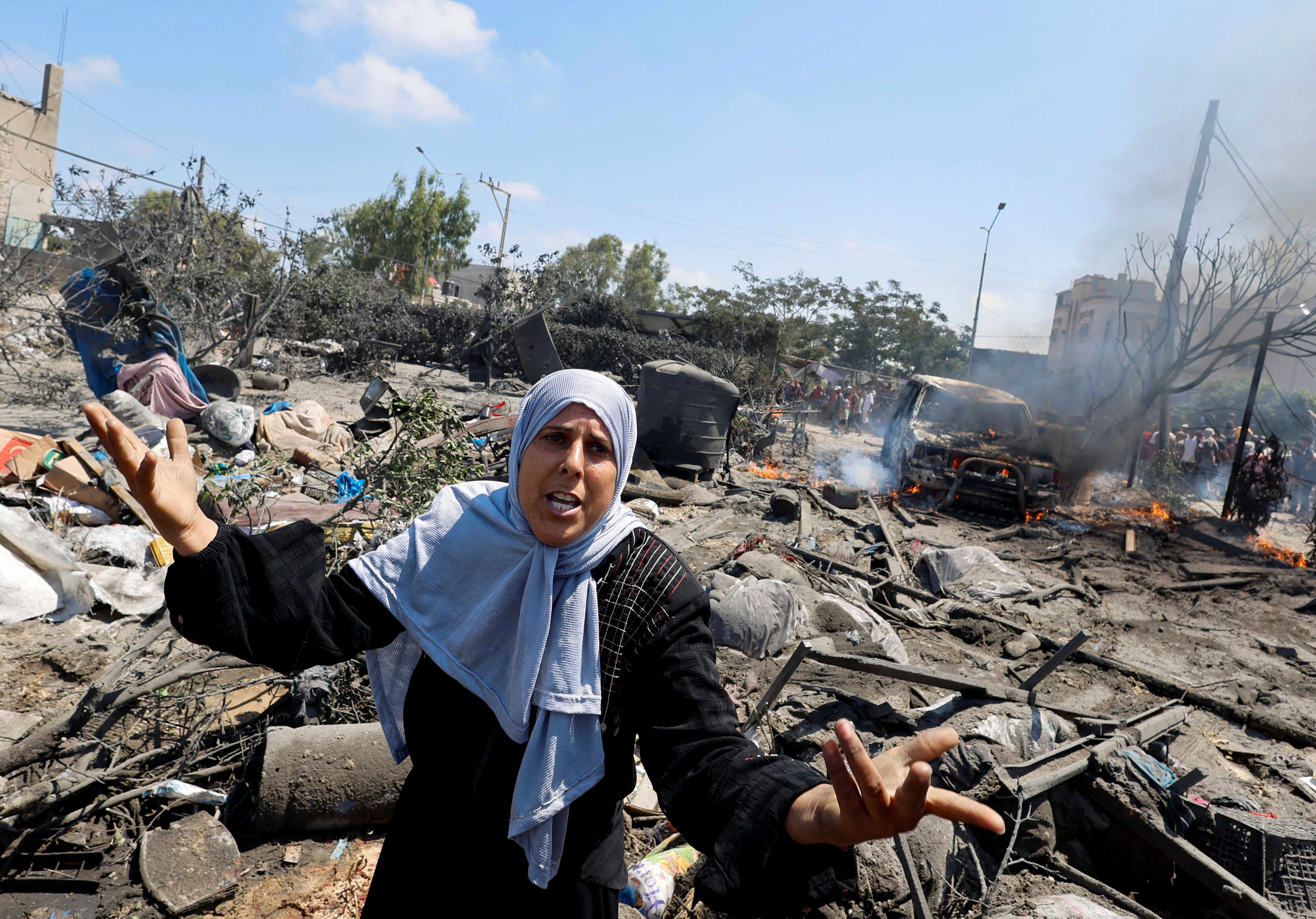 A Palestinian woman reacts following an Israeli attack on a tent camp in al-Mawasi in southern Gaza