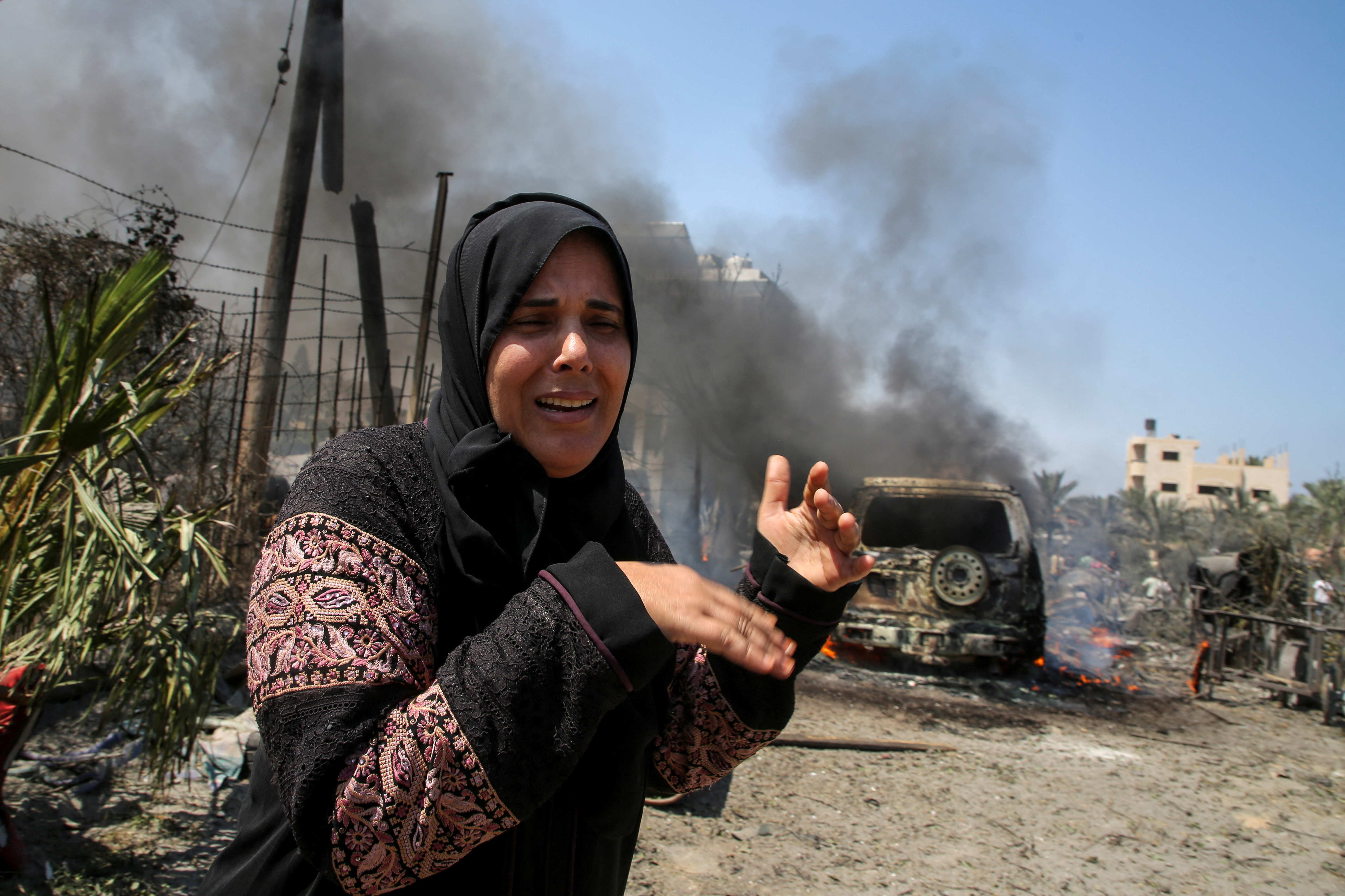 A woman reacts in the aftermath of what Palestinains say was an Israeli strike at a tent camp in Al-Mawasi area
