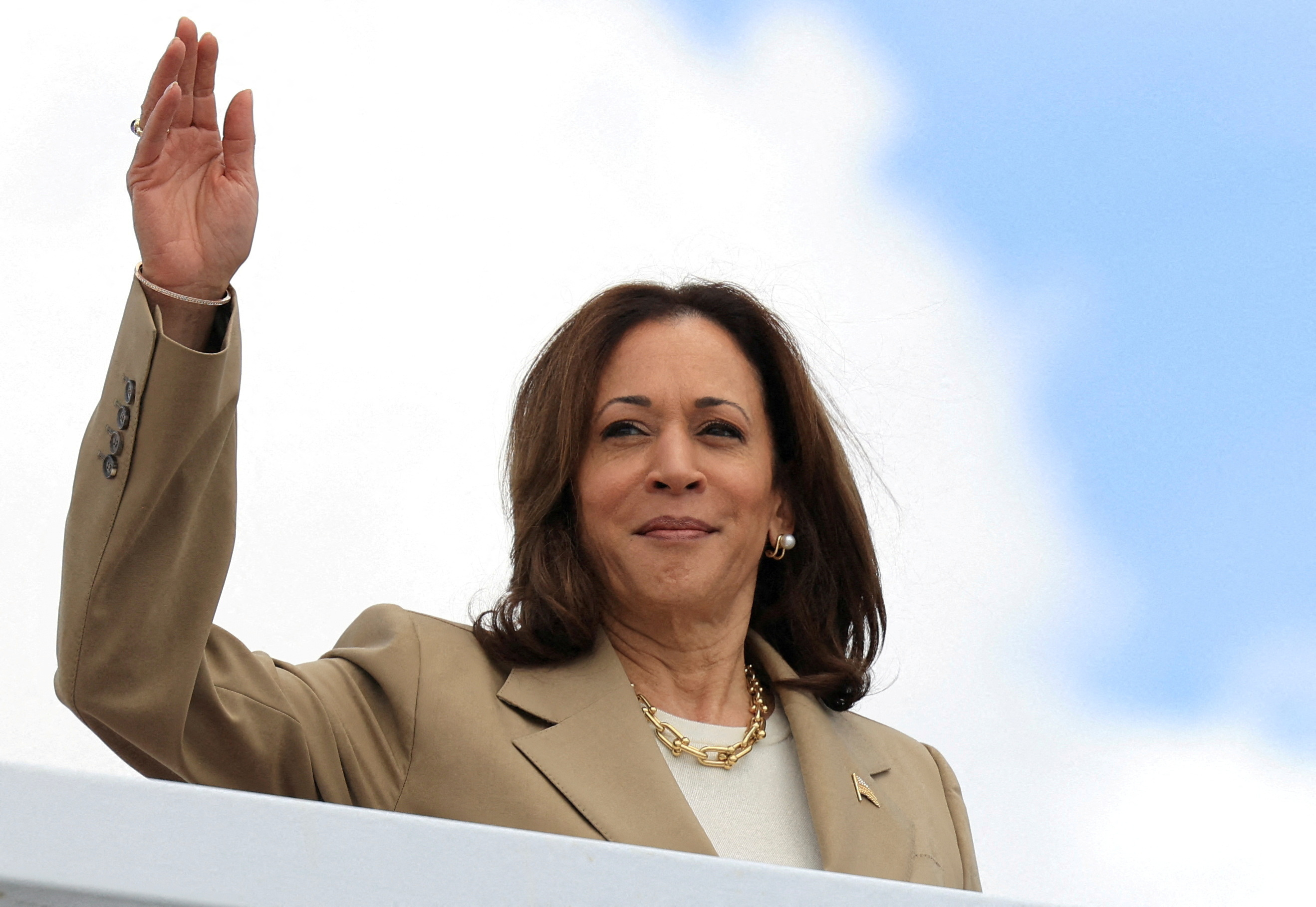U.S. Vice President Kamala Harris waves as she boards Air Force Two to depart on campaign travel to Philadelphia