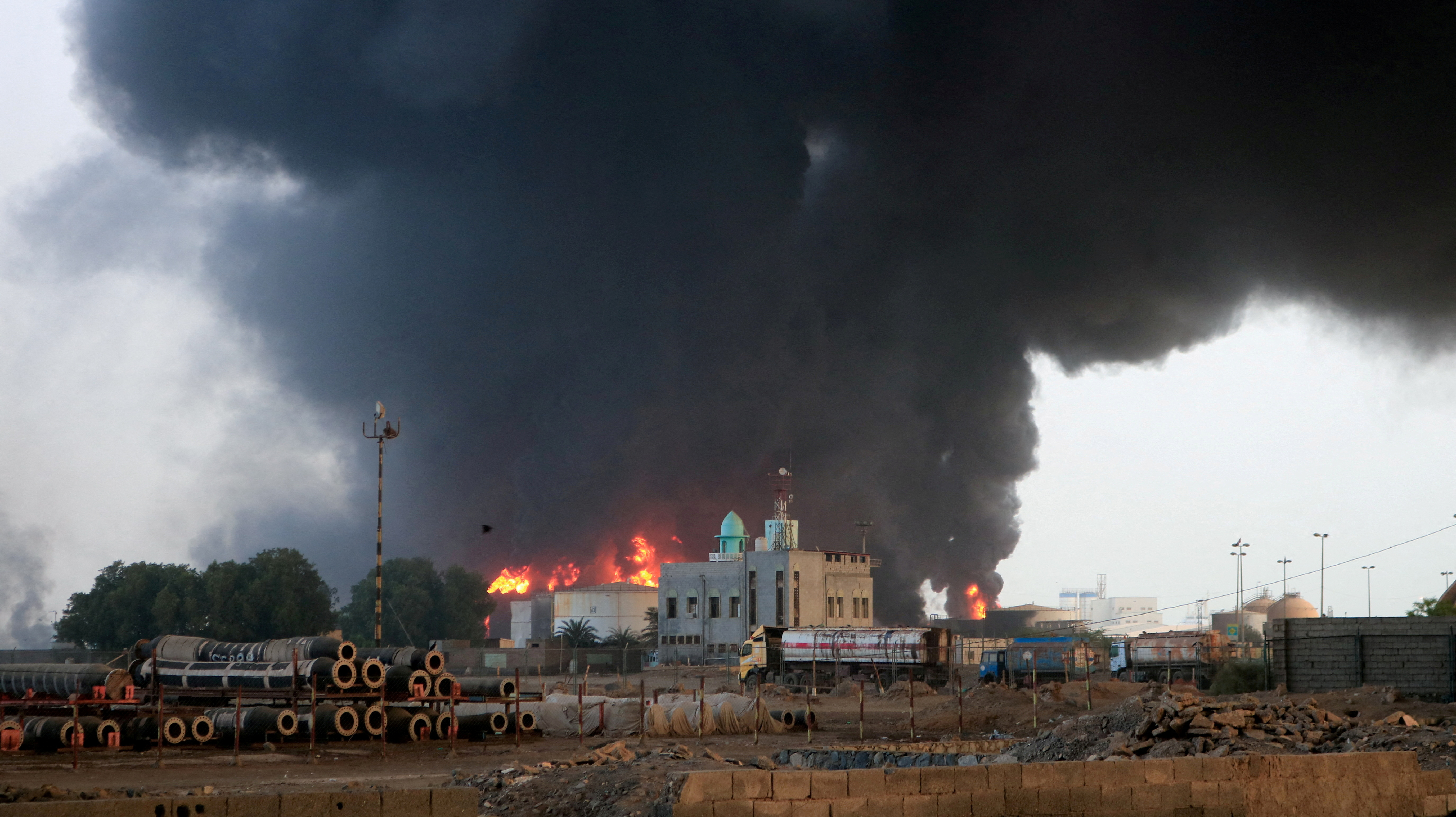 Flames and smoke rise from the site of Israeli air strikes at the port of Hodeidah, Yemen