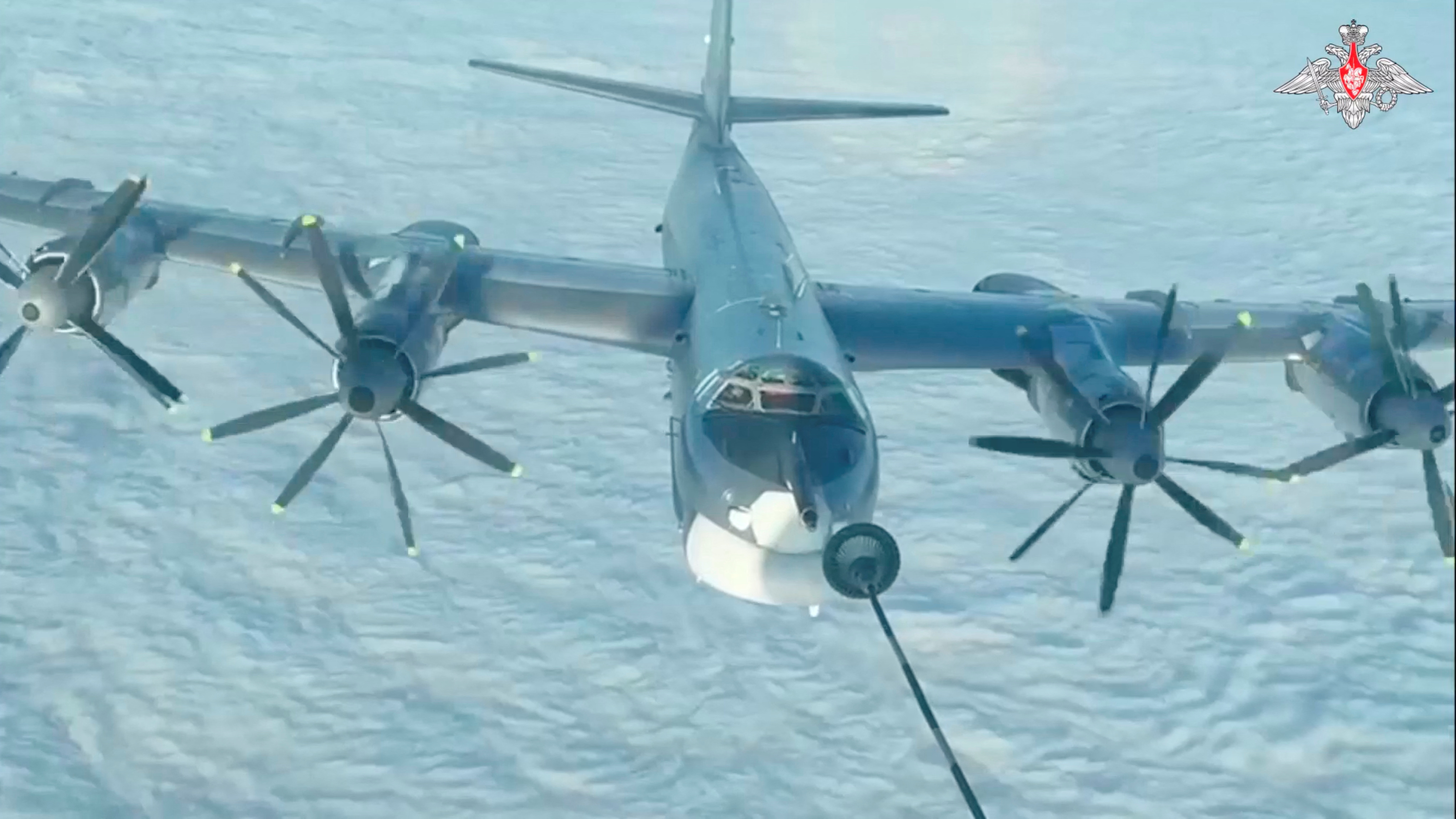 A Russian TU-95 bomber is refuelled during joint Russian and Chinese military plane patrols