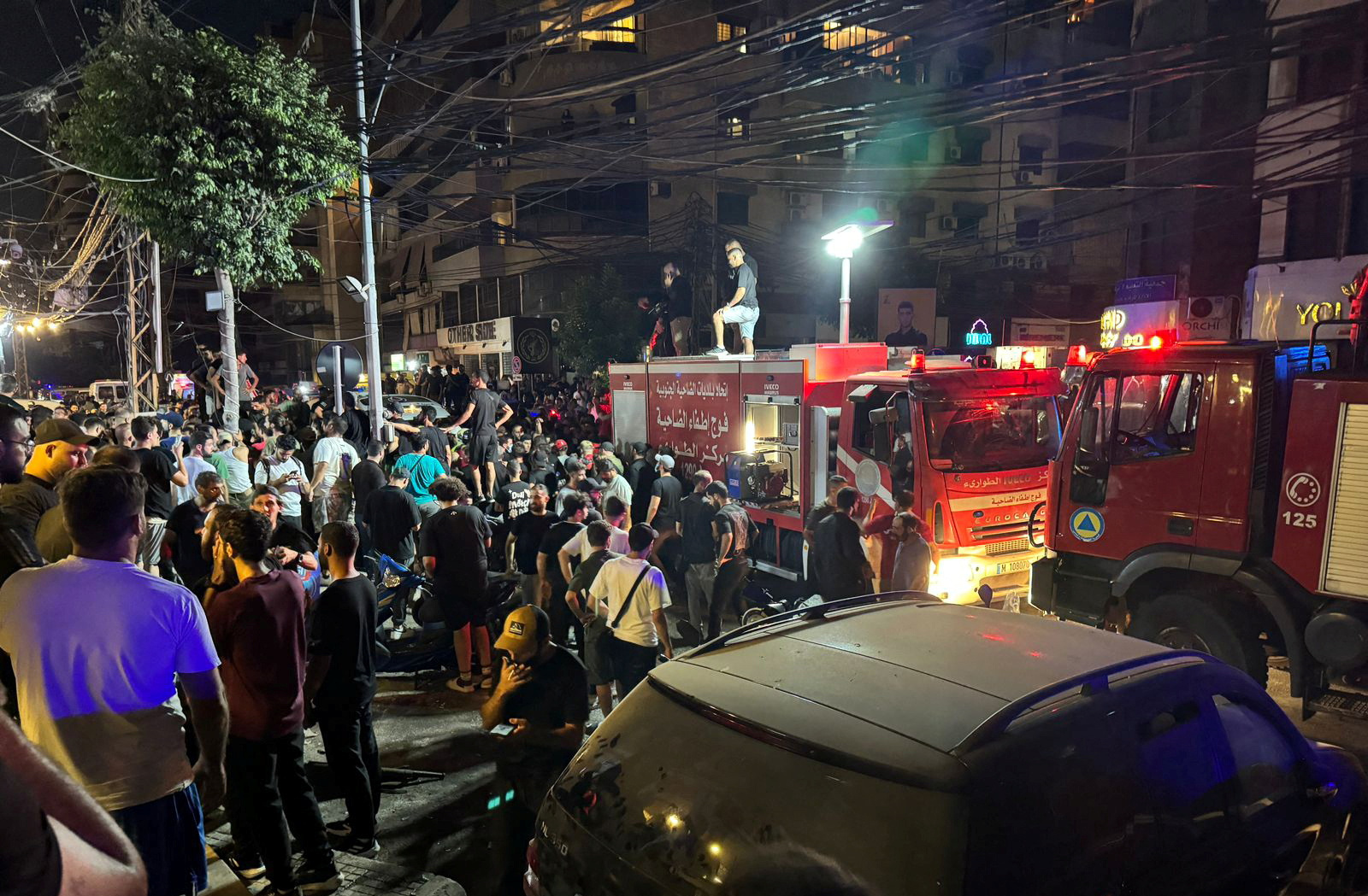 People gather near a site hit by what security sources said was a strike on Beirut's southern suburbs, Lebanon