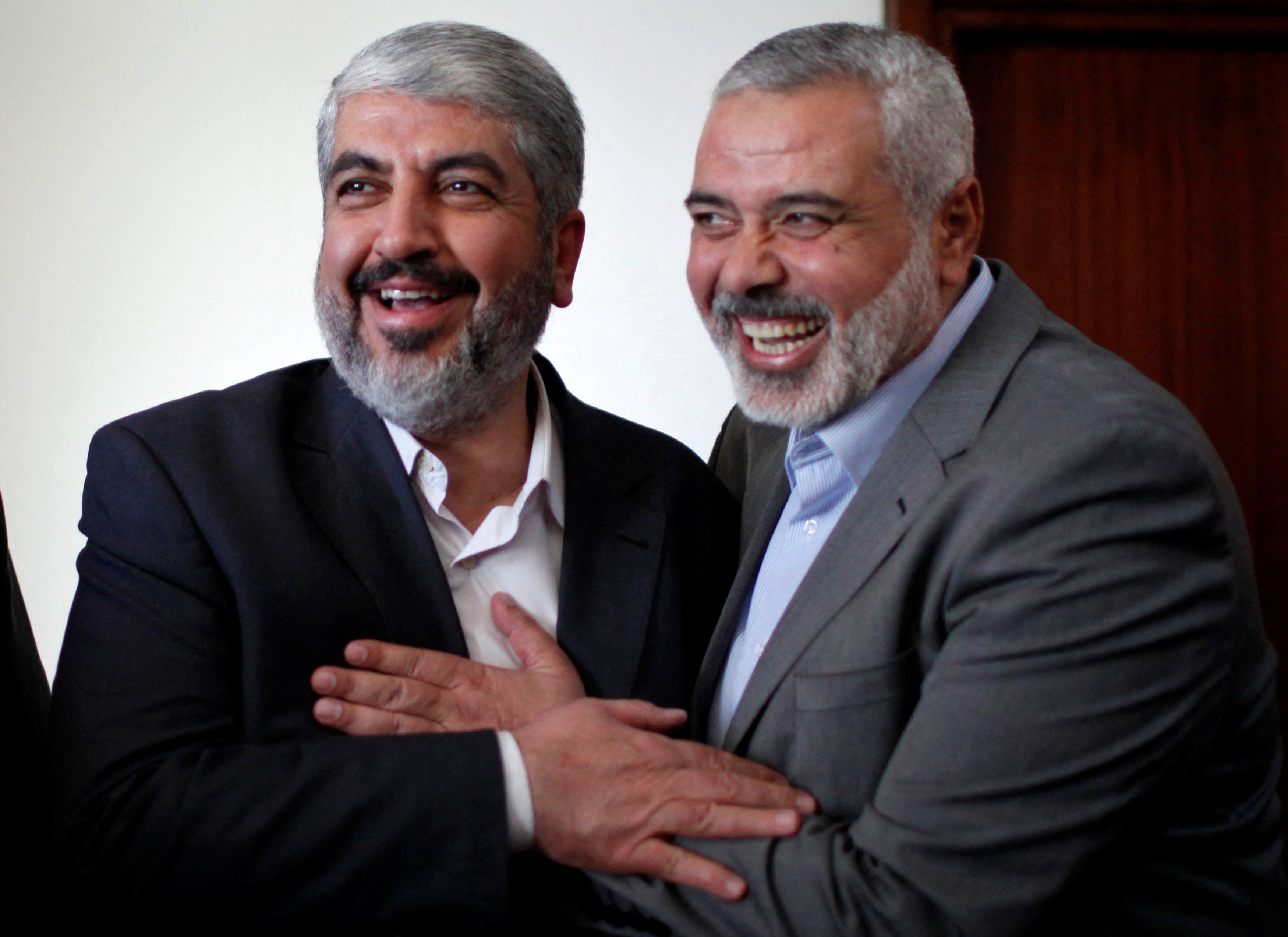 Hamas chief Khaled Meshaal hugs senior Hamas leader Ismail Haniyeh before leaving Gaza 