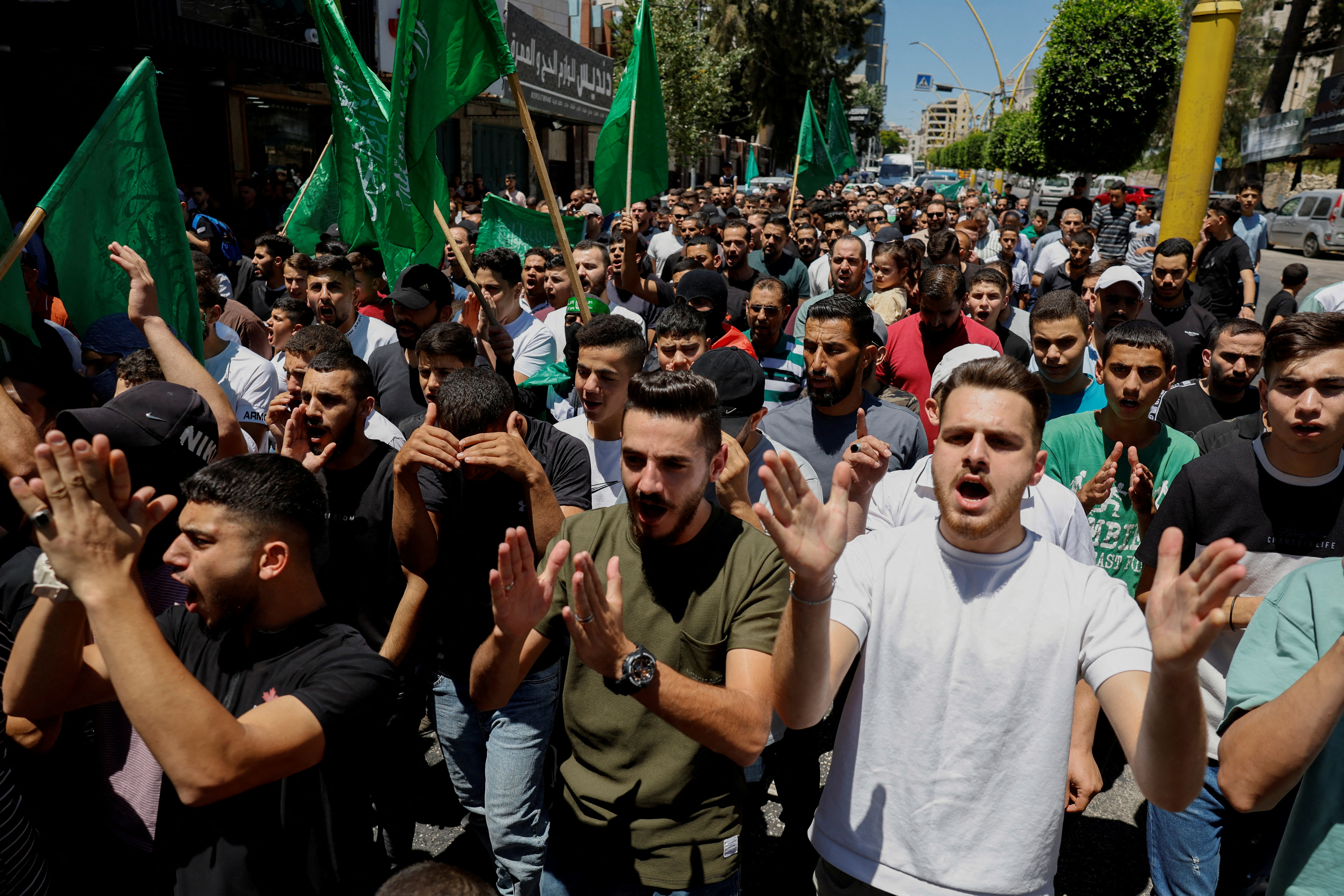 Palestinians attend a protest after the assassination of Hamas leader Ismail Haniyeh in Iran, in Hebron