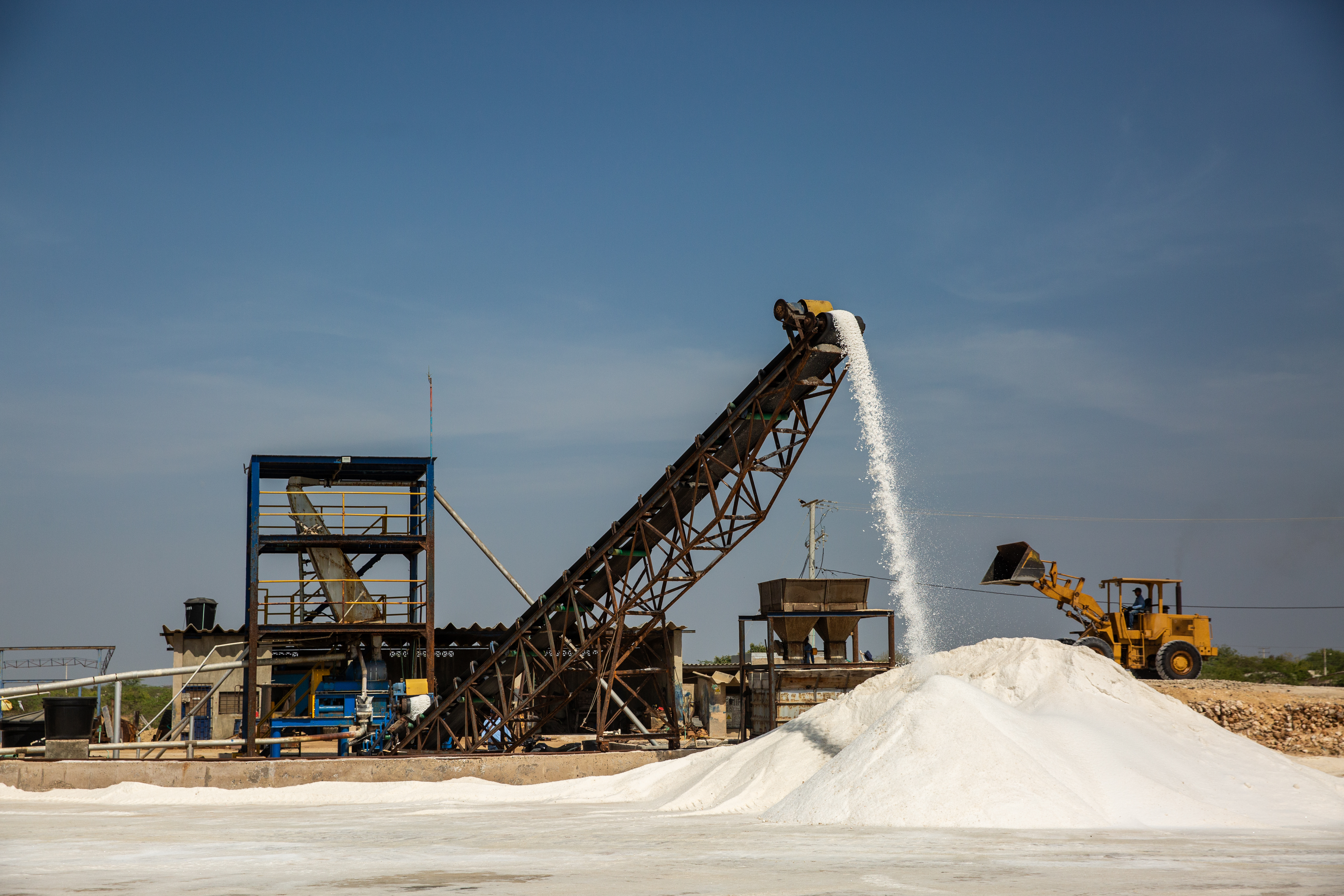 A piece of heavy machinery processes salt outdoors in La Guajira.
