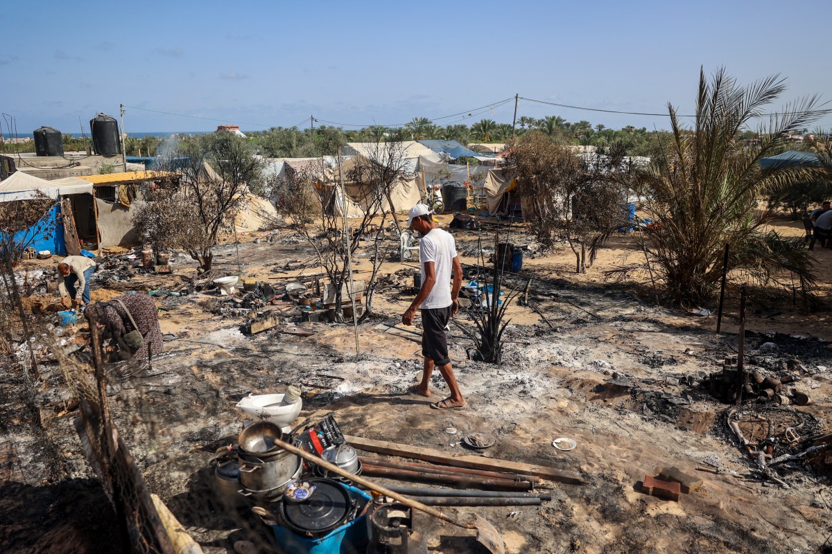 Palestinians collect salvageable items following an Israeli raid in the al-Mawasi area, northwest of the city of Rafah on June 29, 2024, amid the ongoing conflict between Isreal and the militant Hamas movement. (Photo by Eyad BABA / AFP)